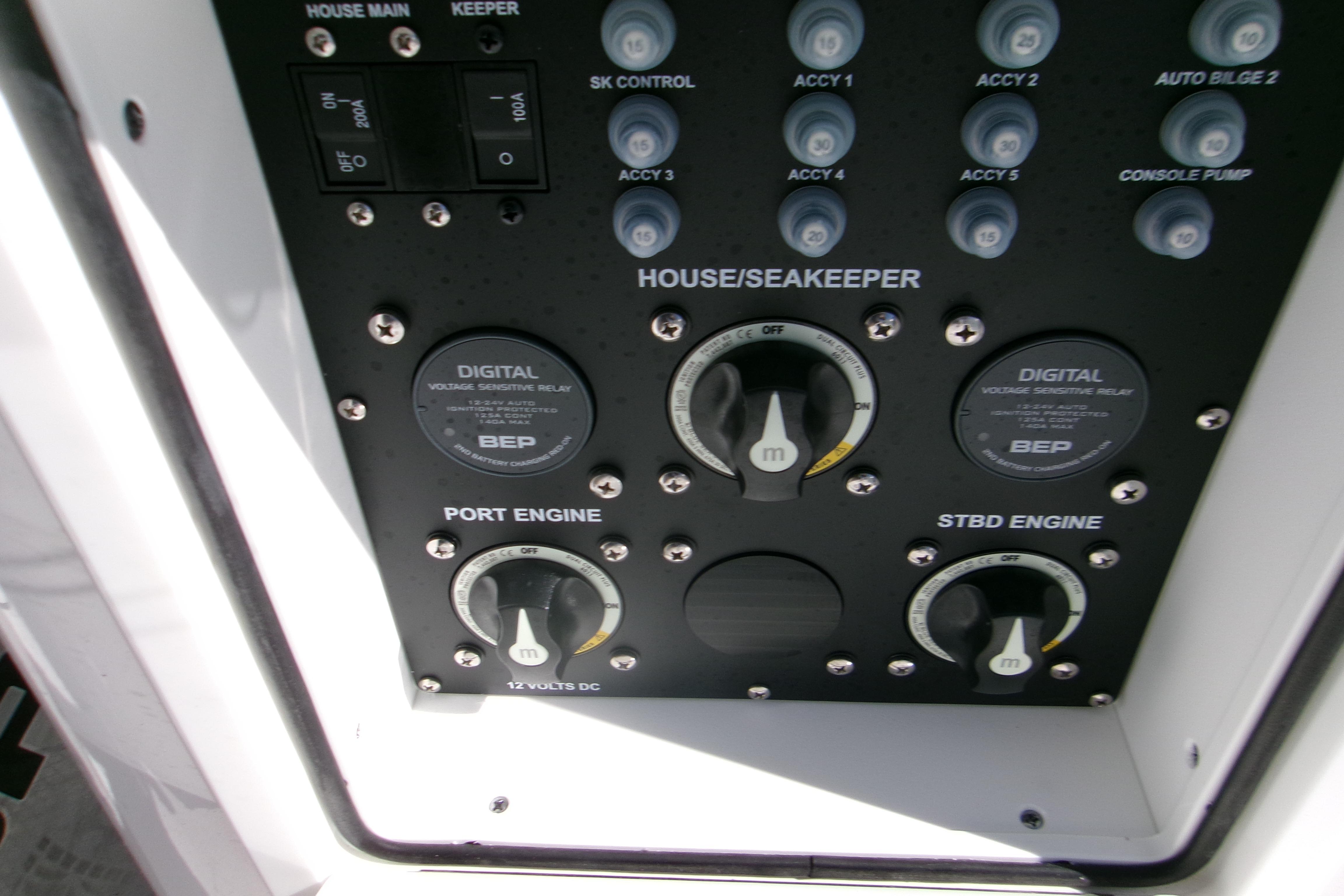 Control panel of 2026 Sportsman Heritage 321 Center Console boat, featuring engine and accessory switches.