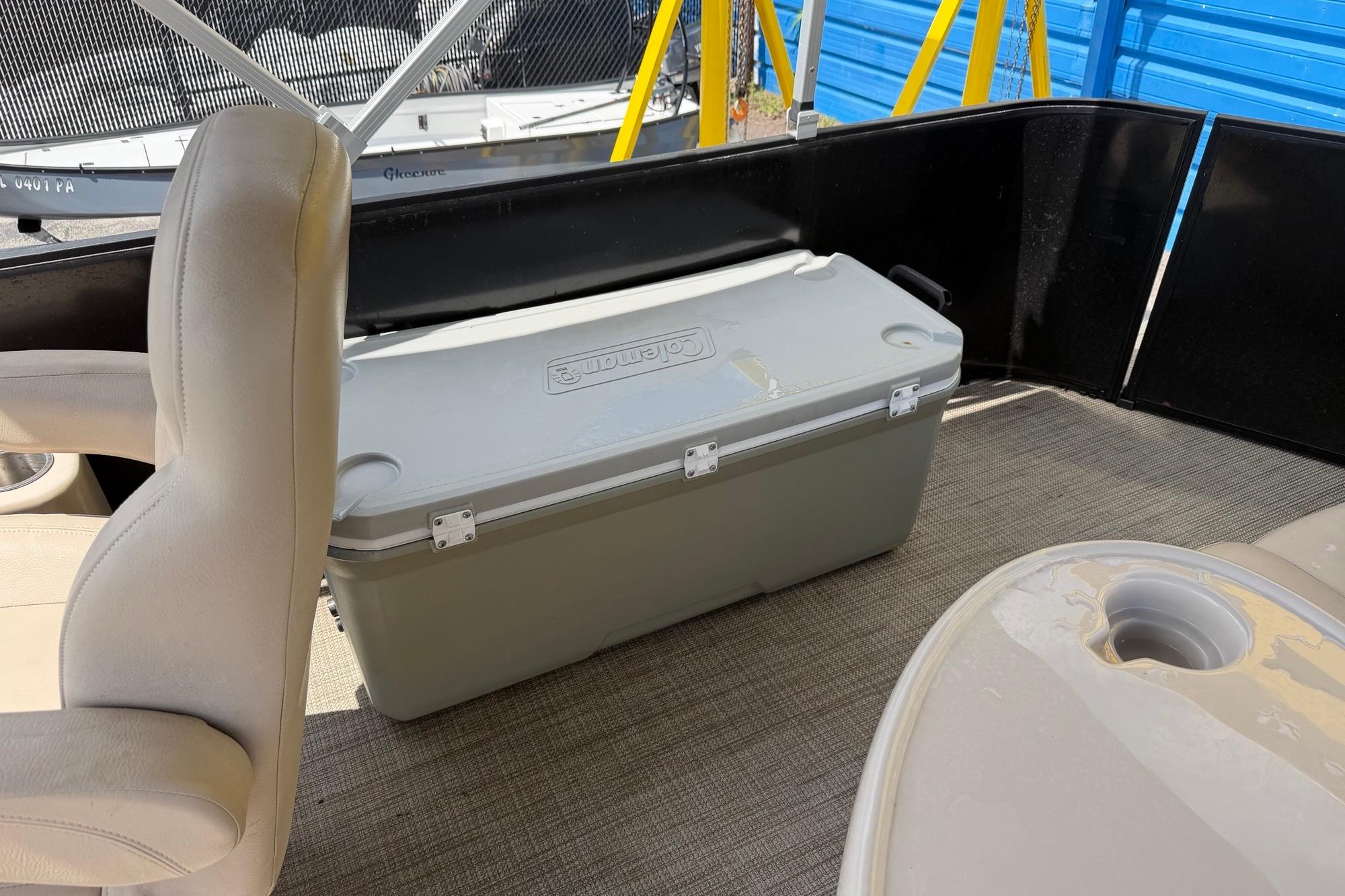 Interior of 2022 Bentley Pontoons 240 CRUISE with cooler and seating.