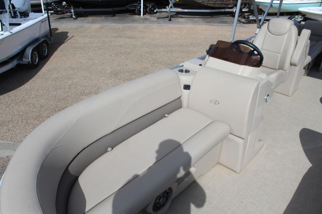 2021 Avalon VLS Quad Lounge 22 FT boat interior with beige seating and steering console.