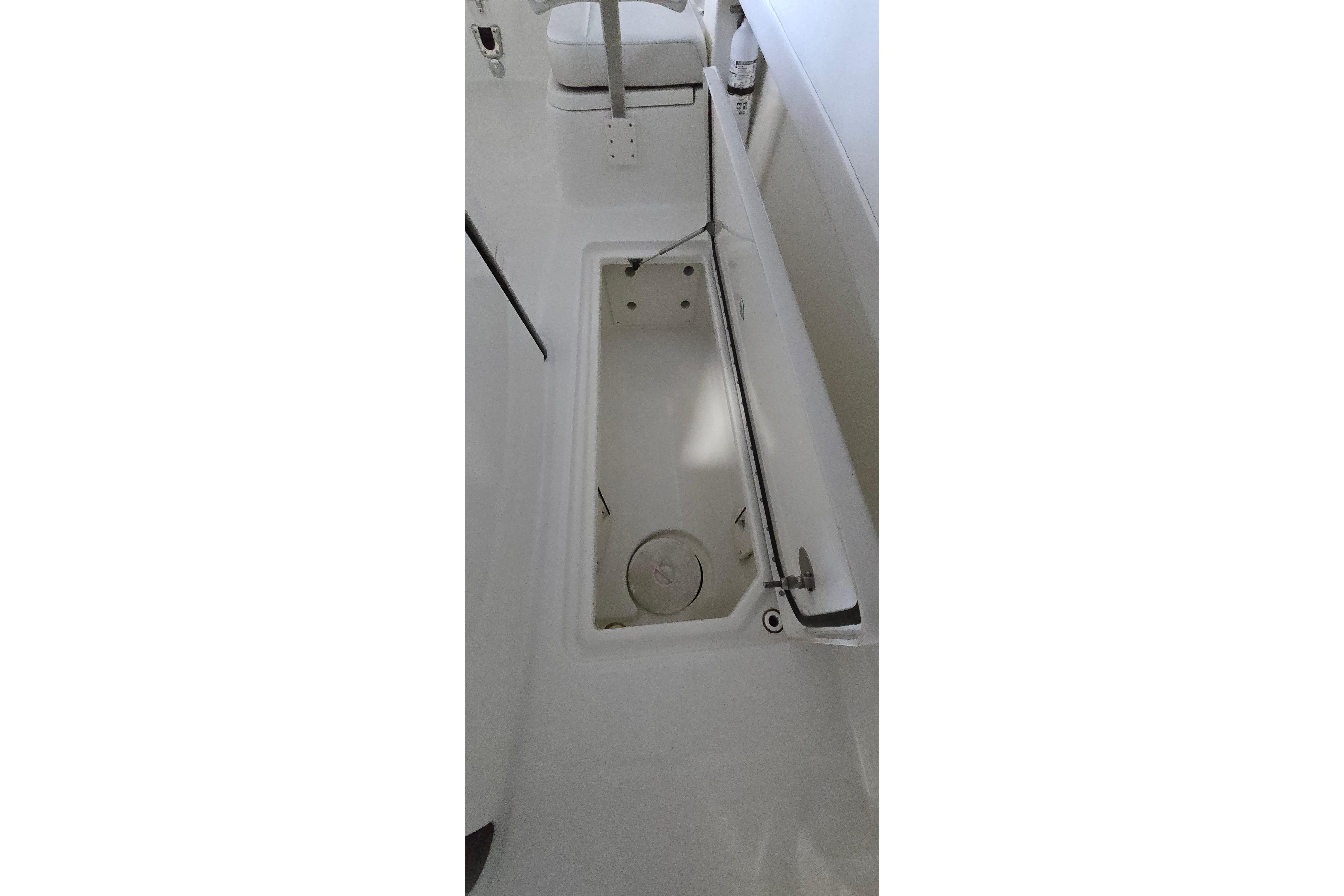 2024 WorldCat 280 CC-X boat storage compartment with open hatch.