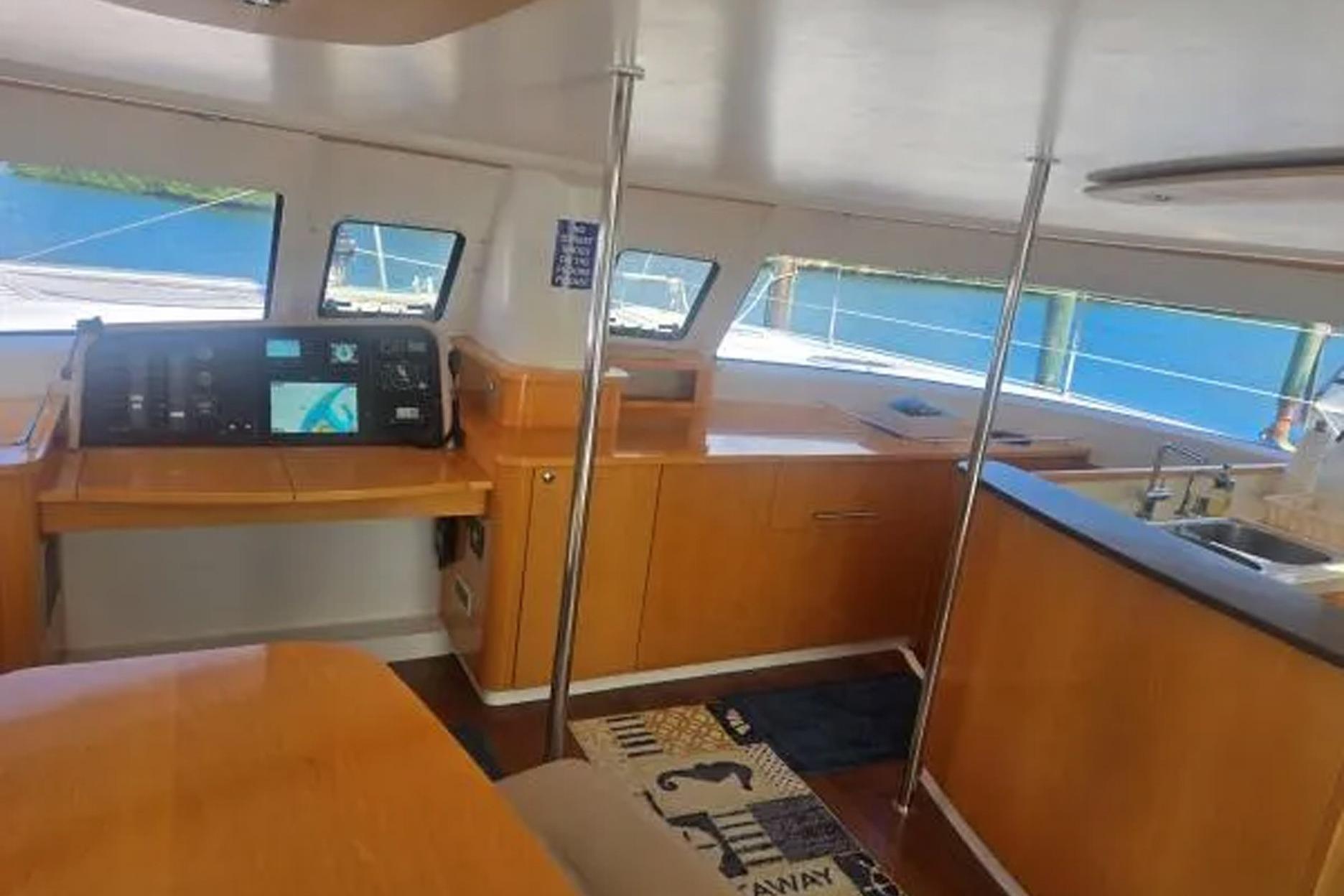 Interior of 2008 Fountaine Pajot Salina 48 catamaran with navigation station and kitchen area.