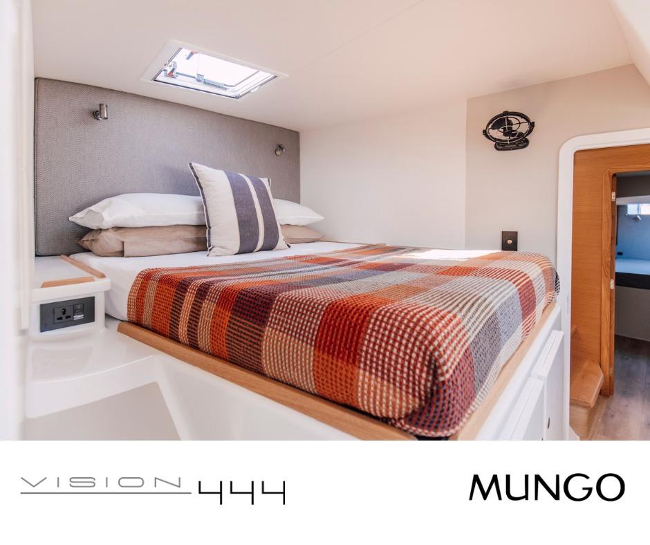 Cozy bedroom interior of Vision 444 yacht, featuring a plaid blanket and modern design, 2026 model.