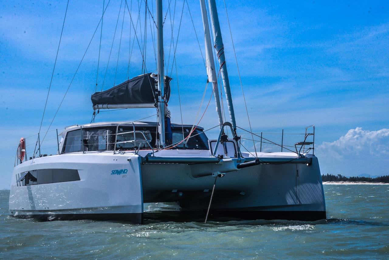 2025 Seawind 1170 catamaran sailing on a sunny day with clear blue skies.