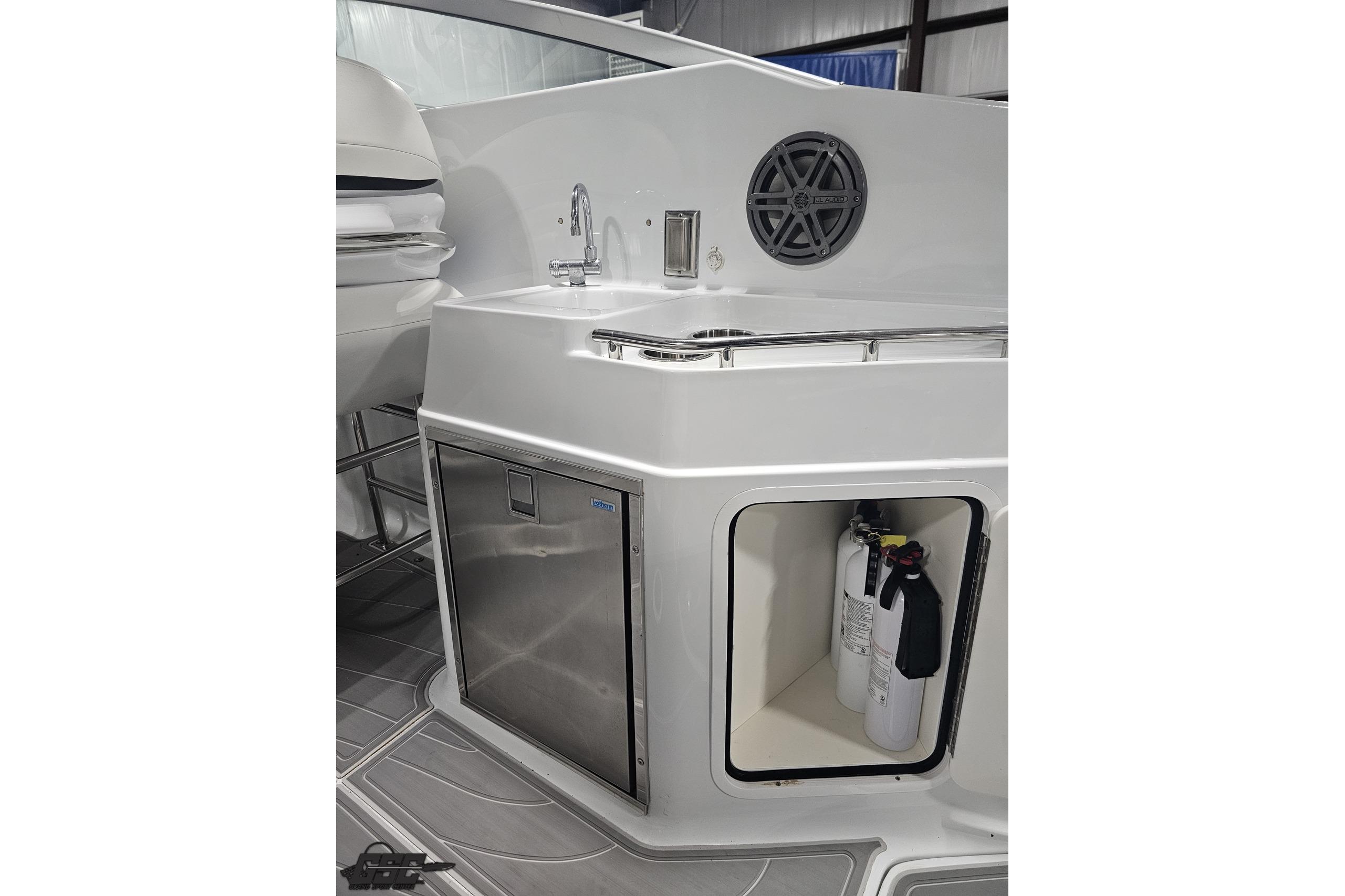 2008 Baja 335 Performance boat interior with sink, storage, and fire extinguisher.