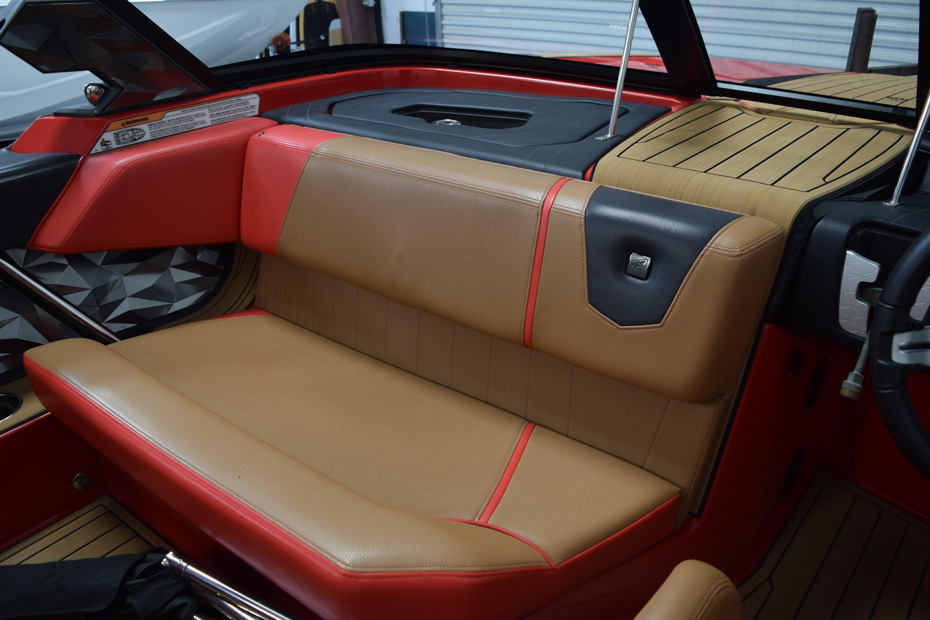 2024 Nautique Ski Nautique interior with tan and red seating, modern design.
