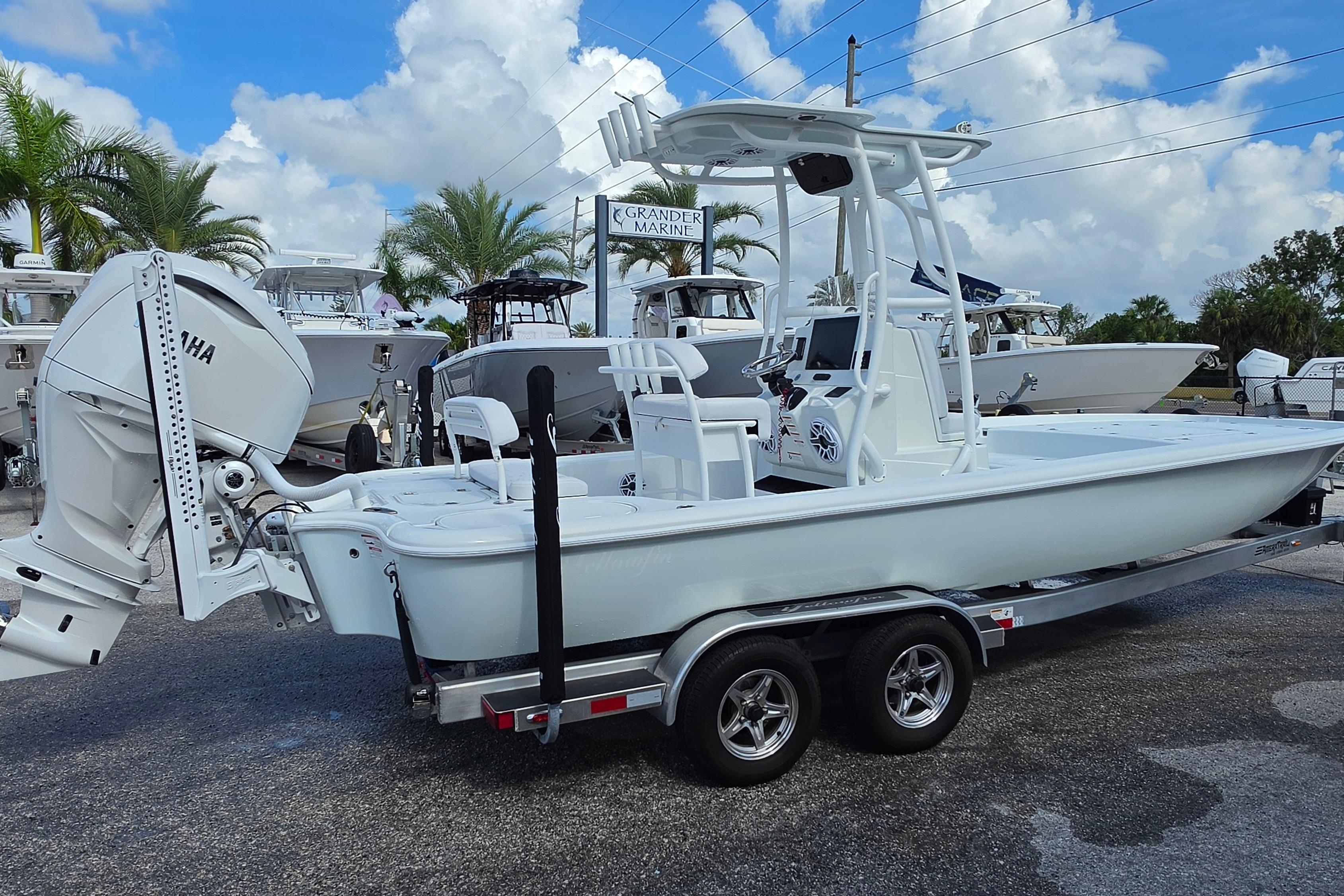 2026 Yellowfin 24 Bay CE boat on trailer, displayed outdoors with palm trees.