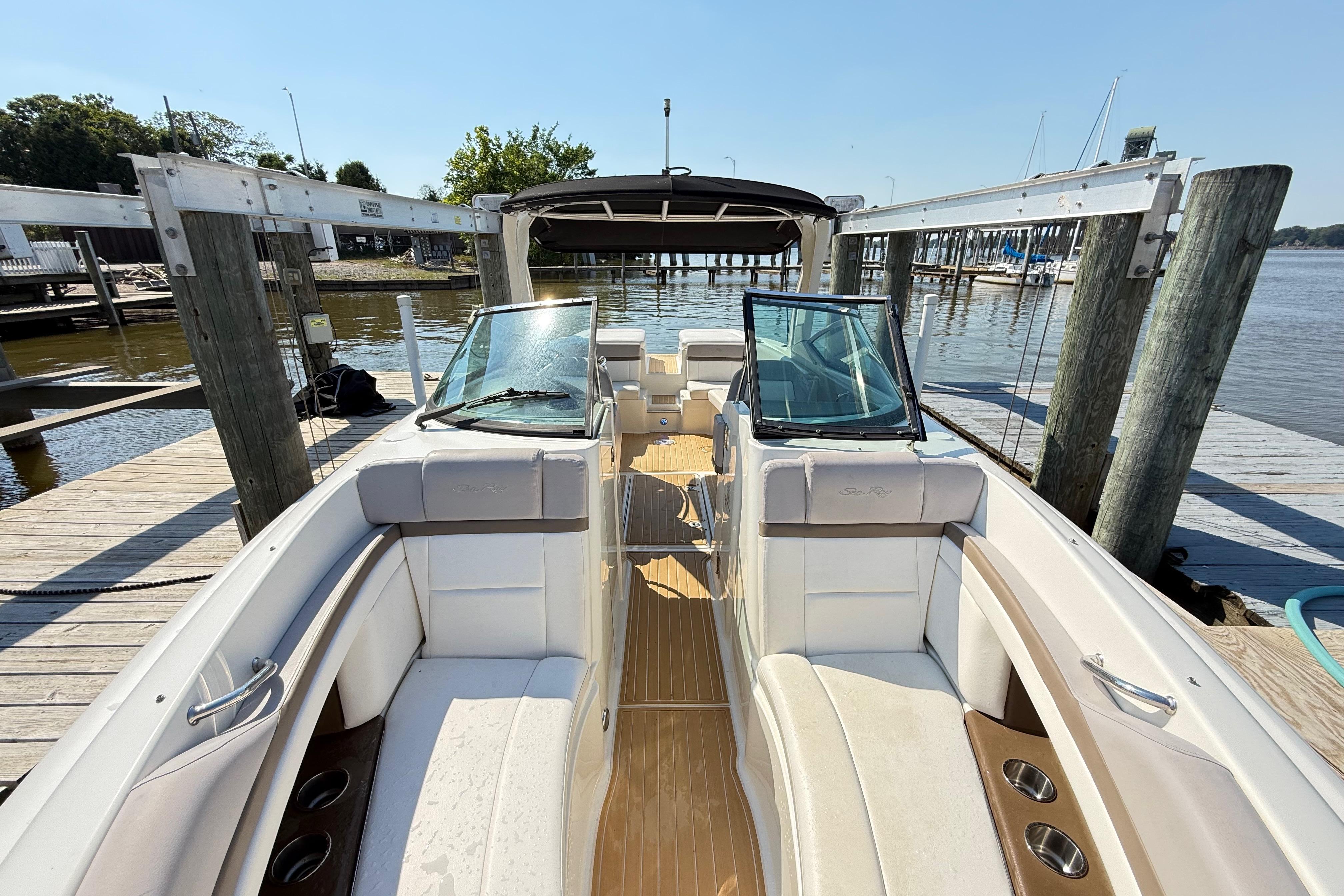 2011 Sea Ray 270 SLX boat docked, featuring spacious seating and sleek design.