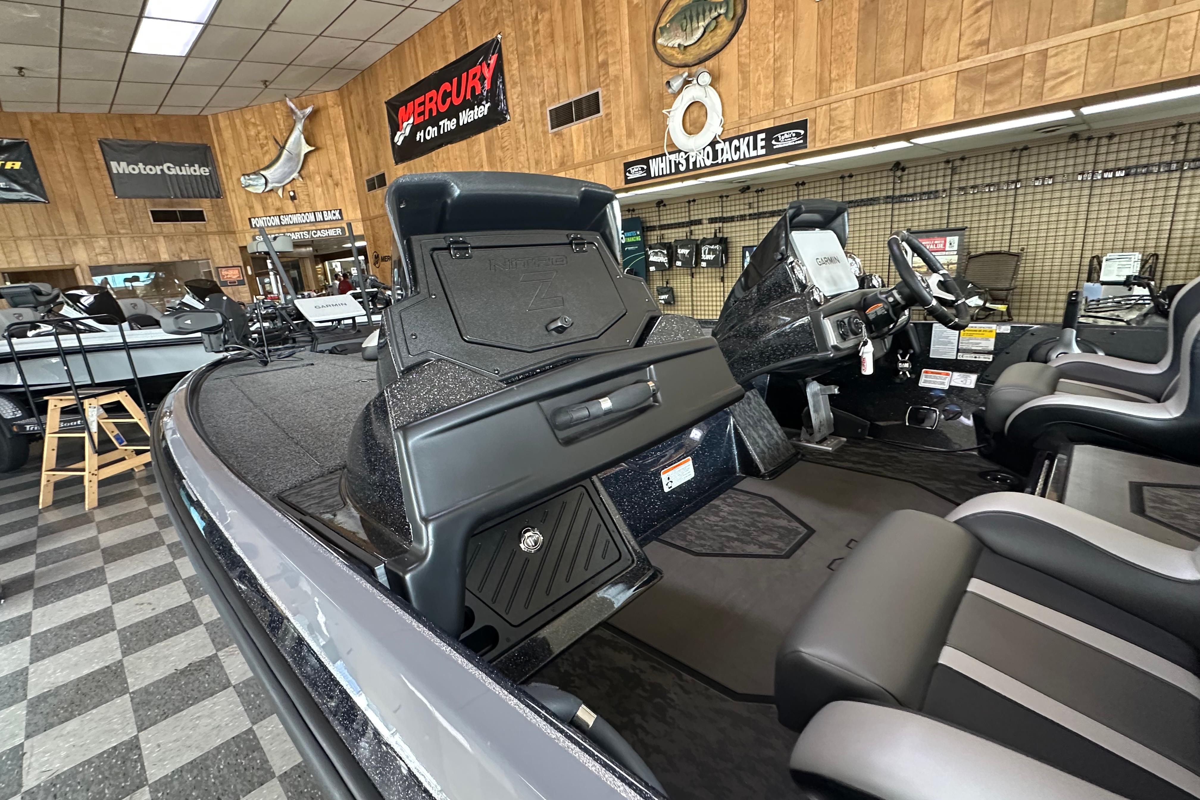 2025 Nitro Z20 XL Pro boat interior in showroom with fishing gear displays.