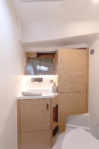 Modern bathroom interior in 2025 Hanse 360 yacht, featuring sleek wood cabinetry and compact design.