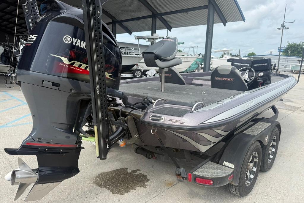 2018 Phoenix 919 ProXP boat with Yamaha VMAX engine, parked under a metal canopy.