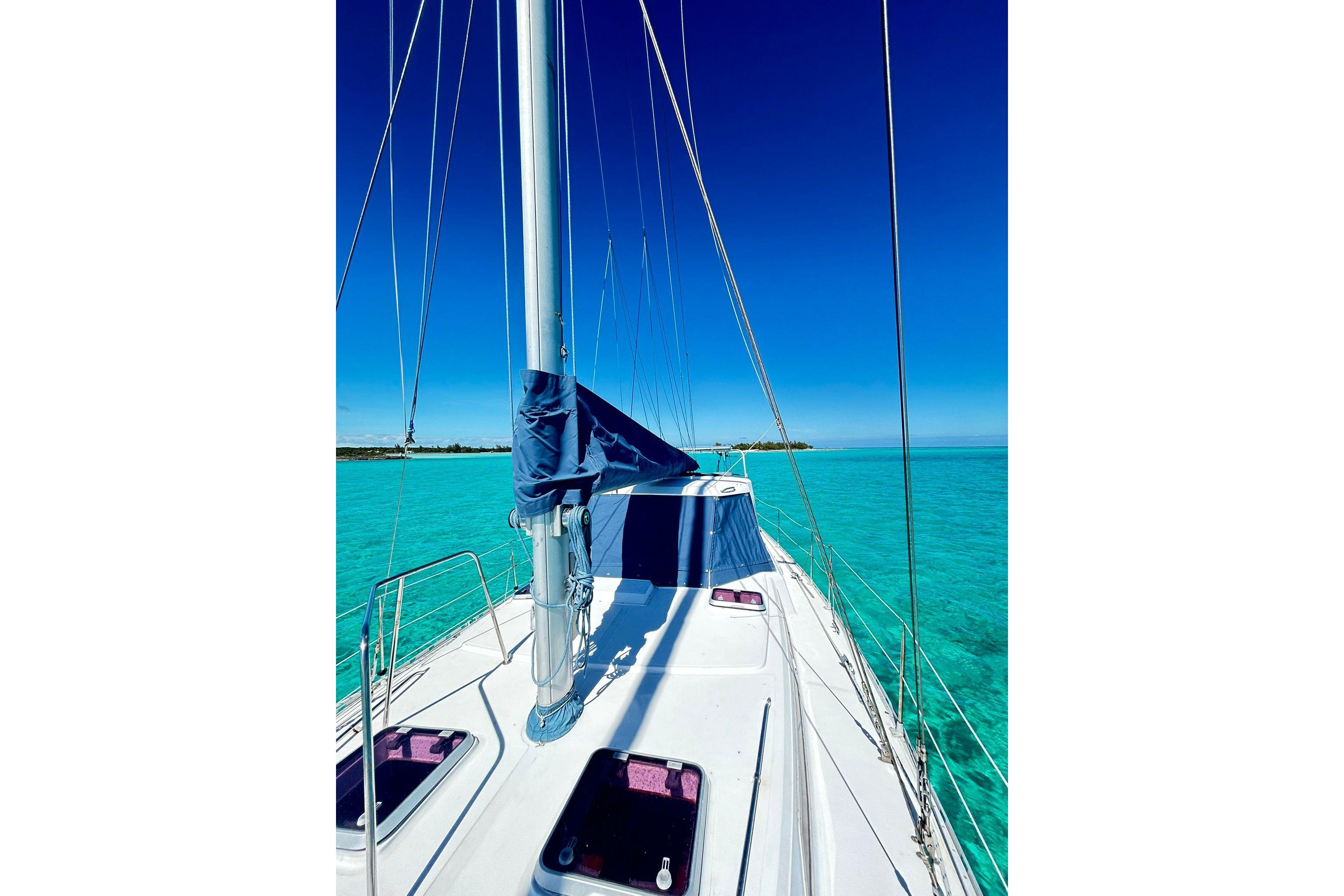Sailing on a 1987 Gulfstar CSY 50 Pilot House in clear turquoise waters.