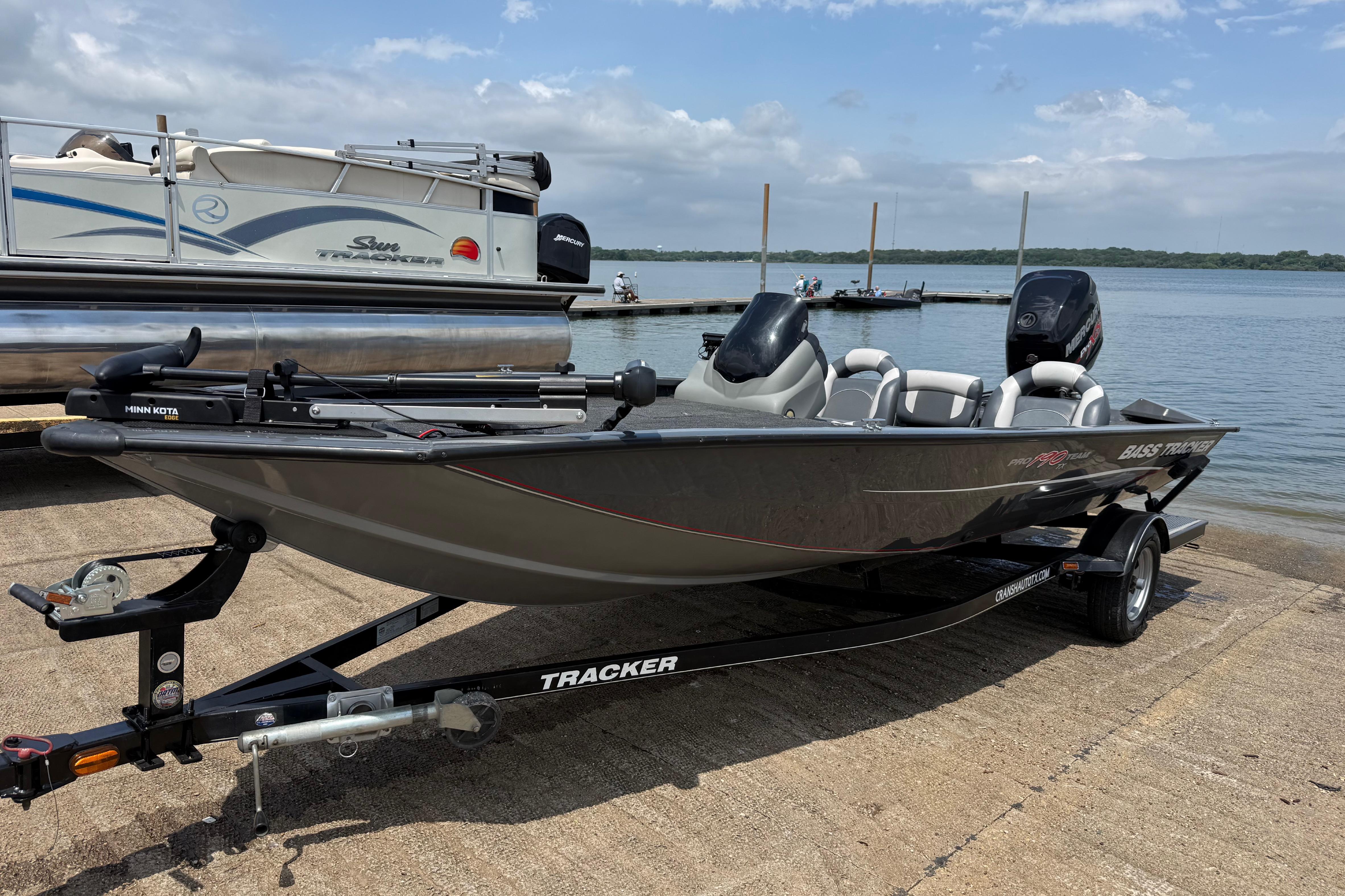 2015 Tracker Pro Team 190 TX boat on trailer by lake.