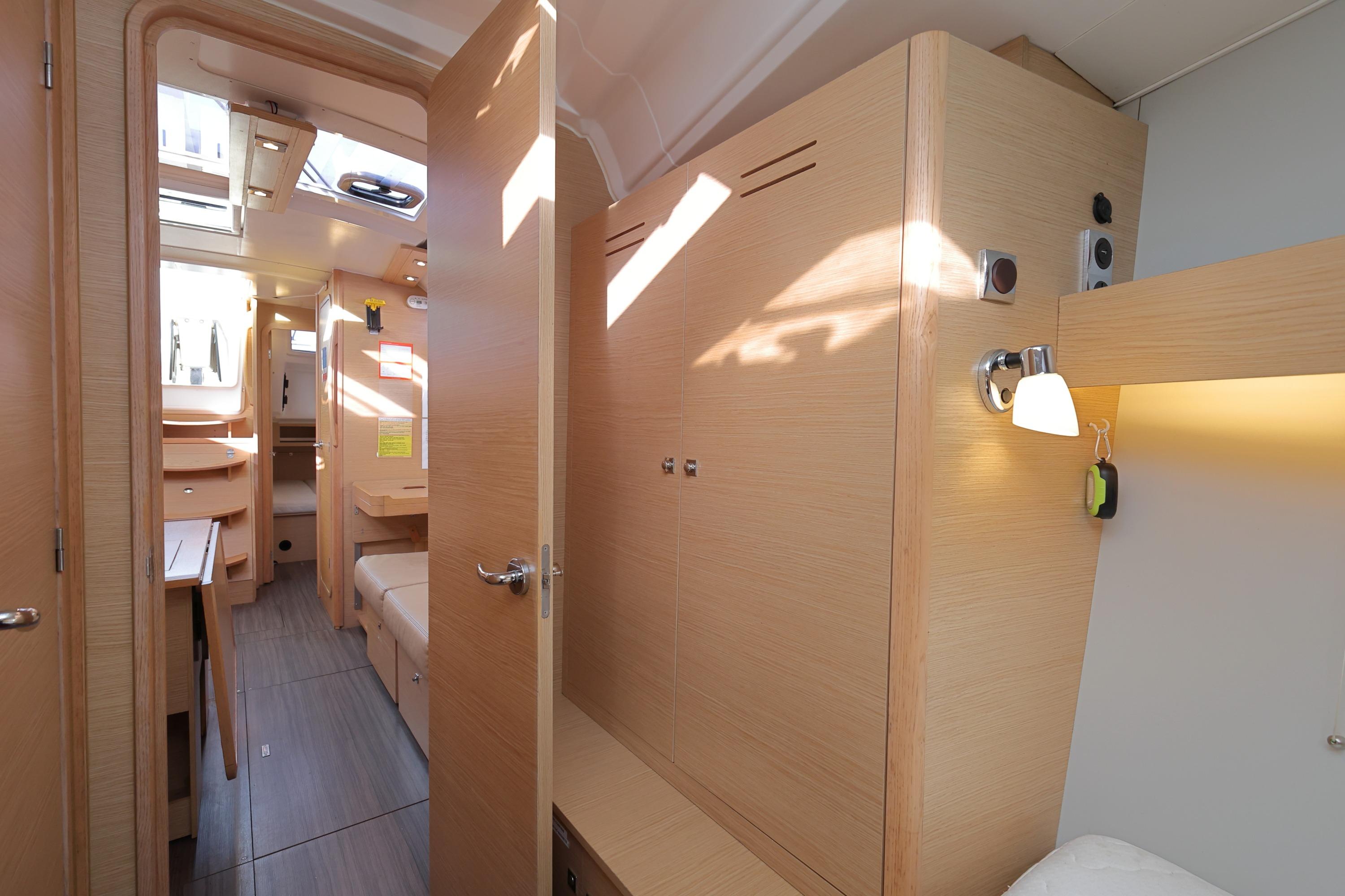 Interior of 2022 Dufour 390 yacht, featuring modern wood finish and ample natural light.