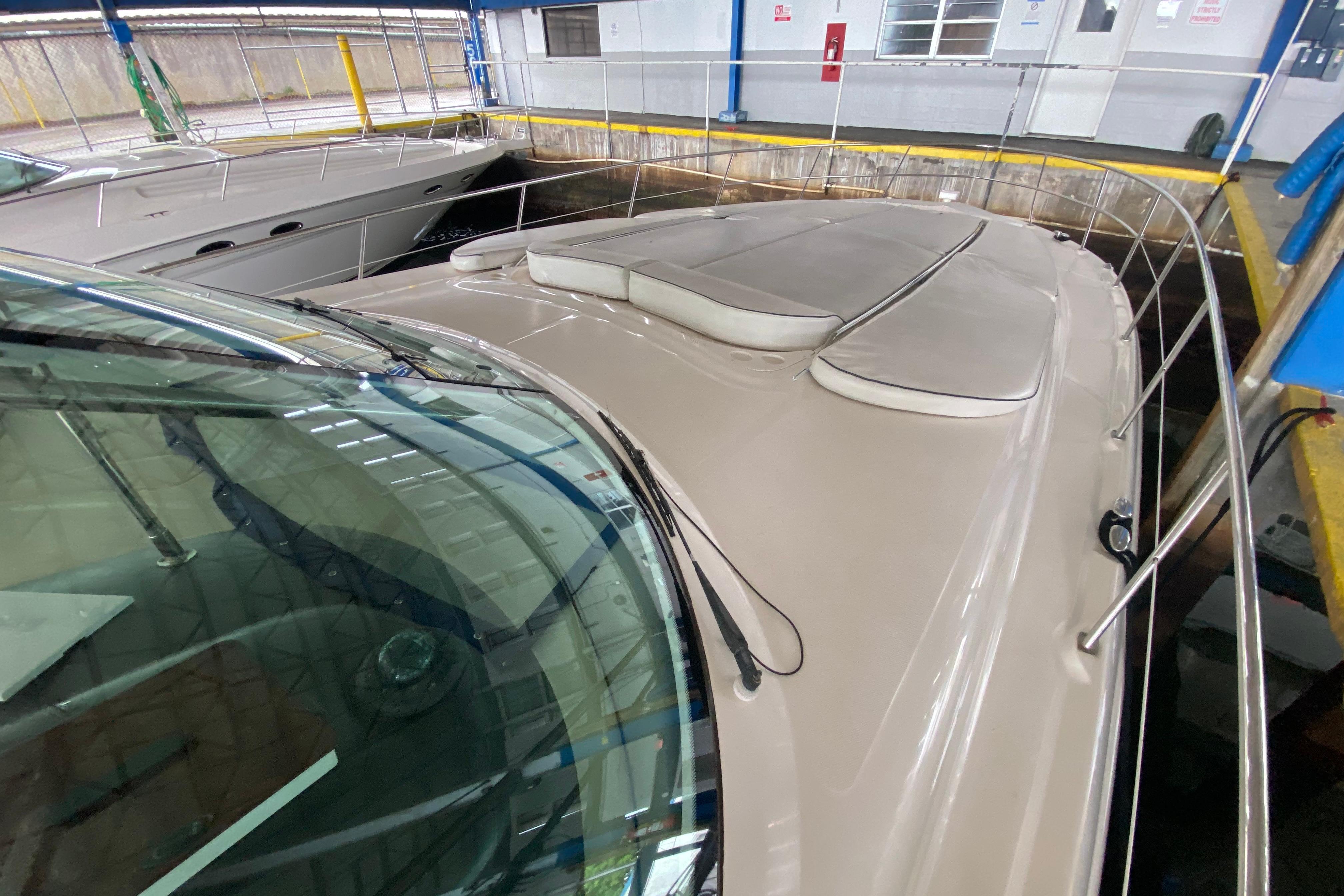 2005 Sea Ray 500 Sundancer yacht docked indoors, showcasing sleek design and spacious deck.