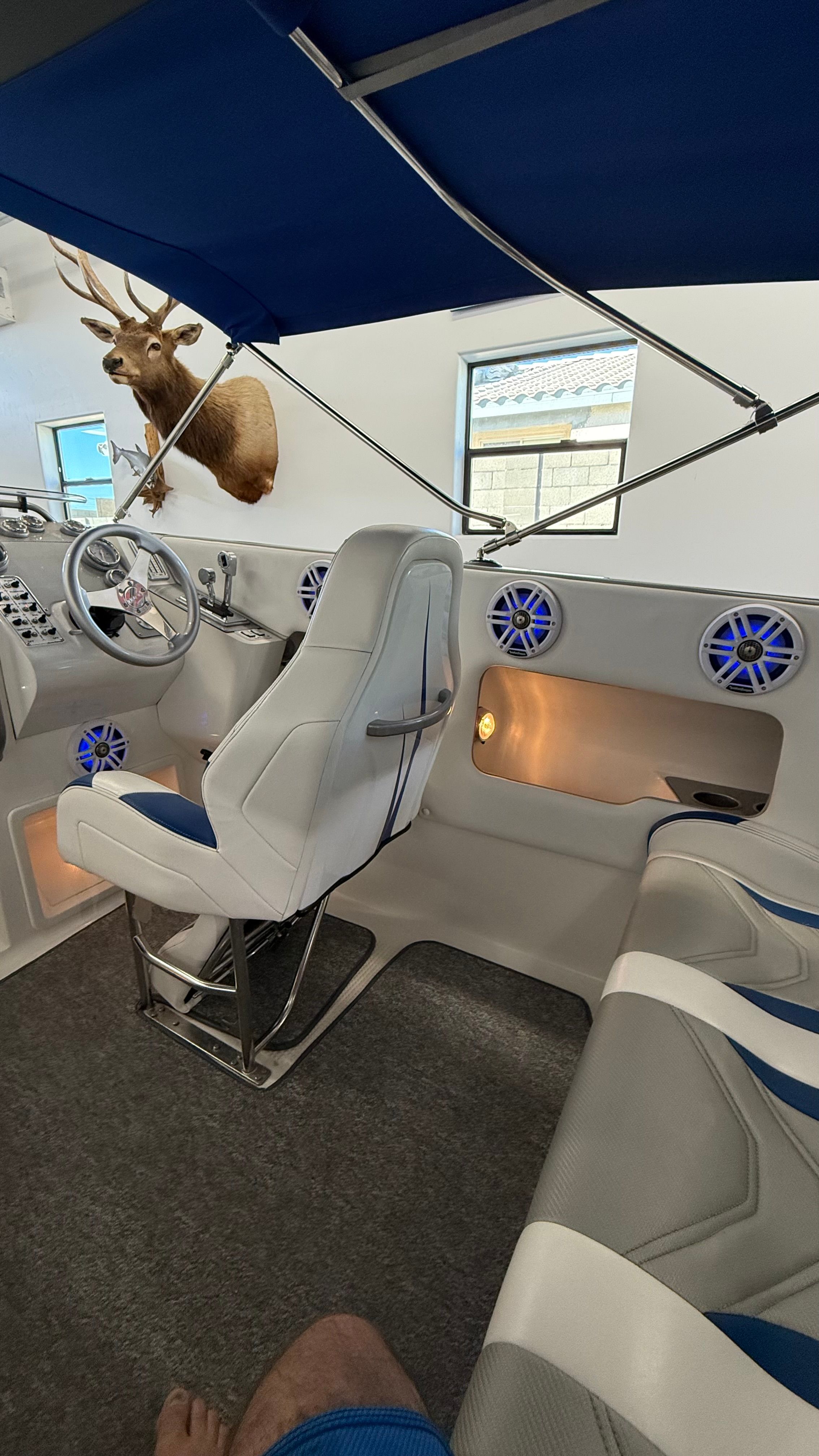 Interior of a 1999 Lavey Craft 2950 NuEra with white seating and blue speakers.