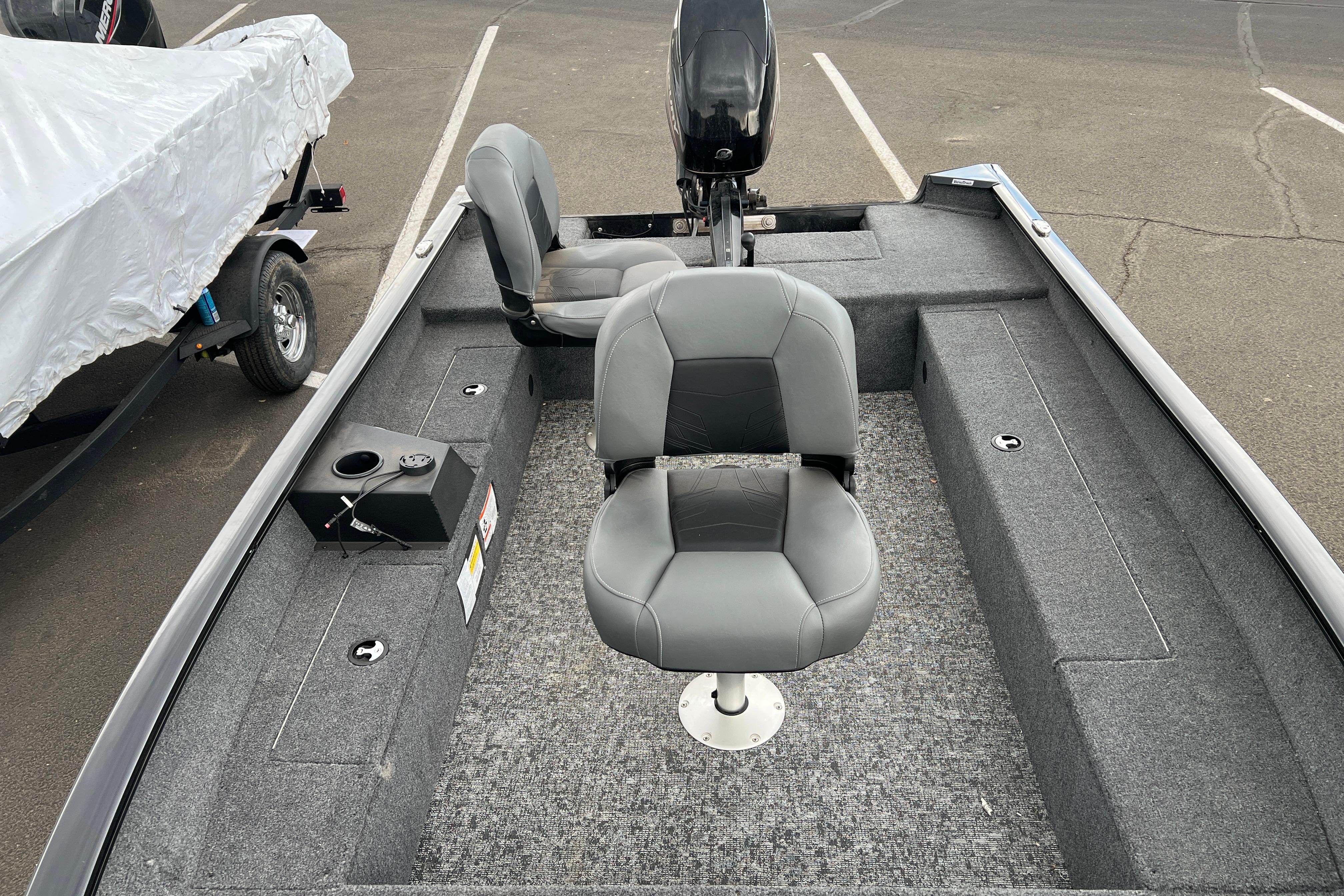 2025 Tracker Super Guide V-16 T fishing boat interior with gray seating and carpeted deck.