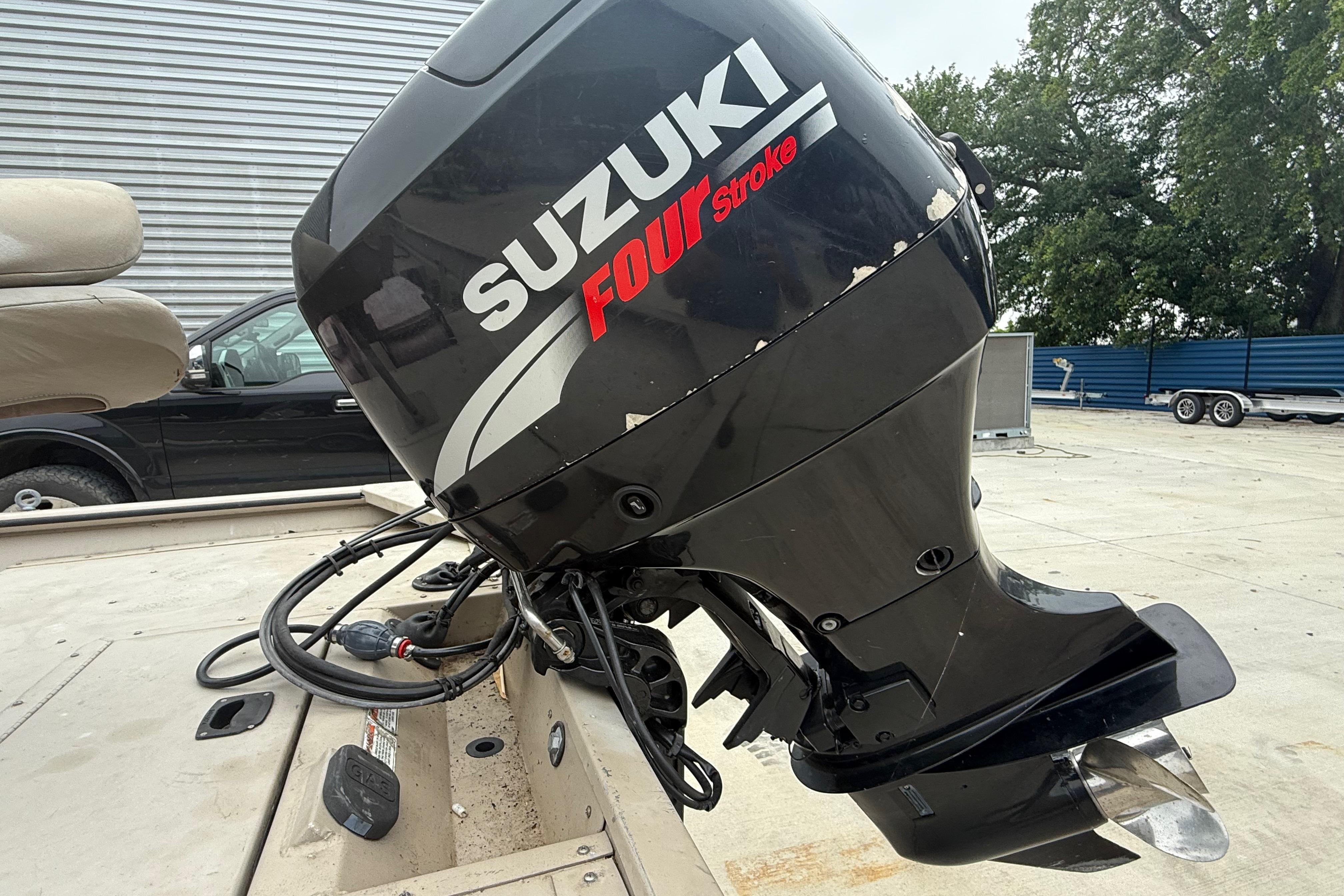 2008 SeaArk 1652 MV boat with Suzuki Four Stroke outboard motor in a parking area.