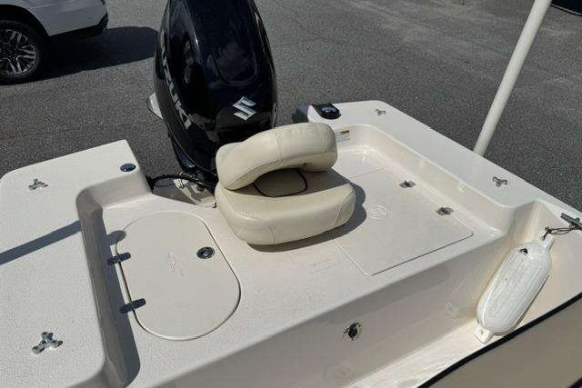 2023 Carolina Skiff 192 JLS boat with outboard motor and cushioned seating.