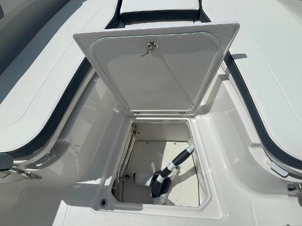 2023 Robalo R270 storage compartment with open hatch.