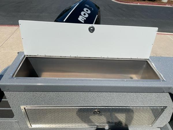 Open storage compartment on 2024 Spartan 220 Maximus boat, featuring durable construction.
