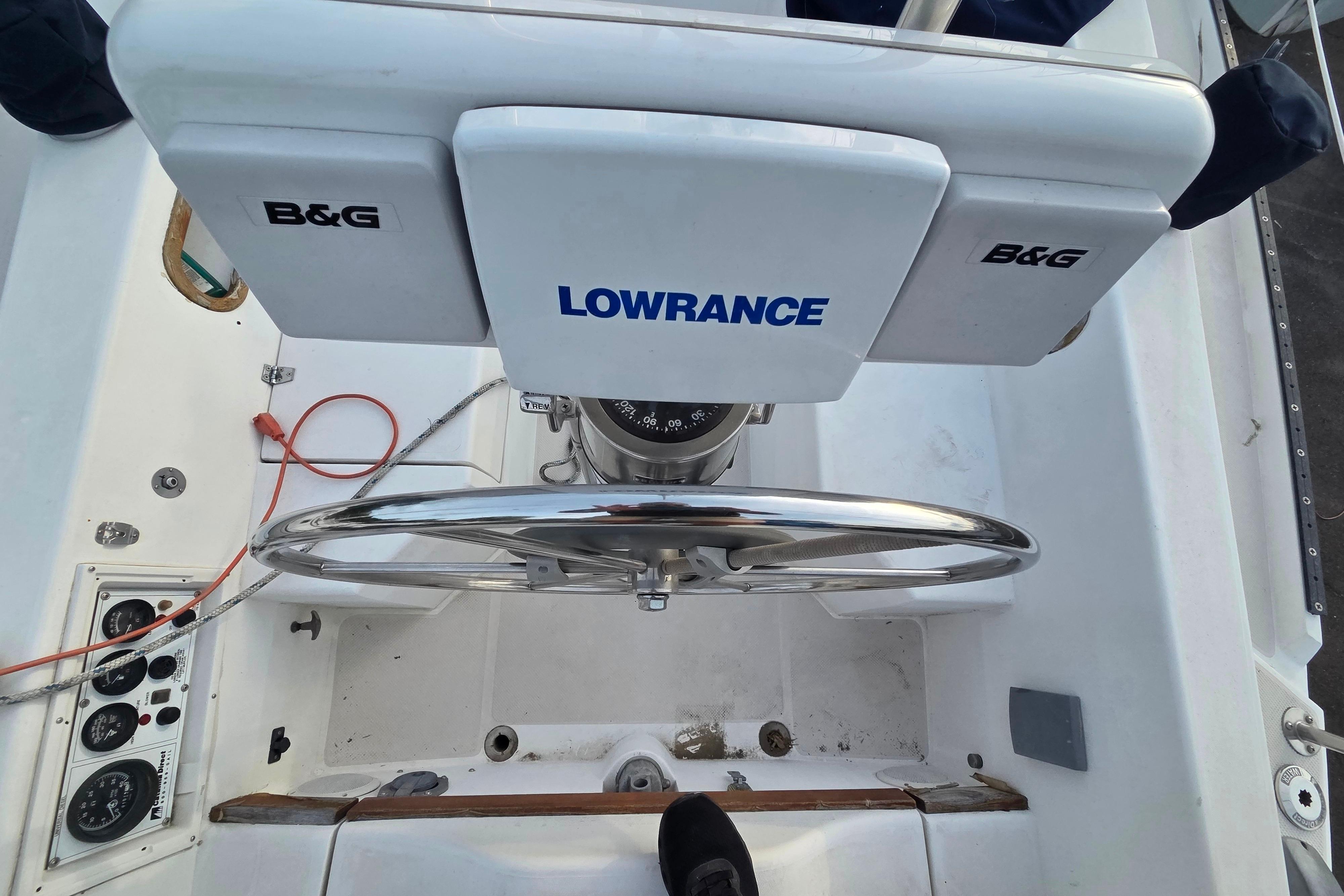 Cockpit of 1986 Catalina 355 sailboat with steering wheel and navigation equipment.