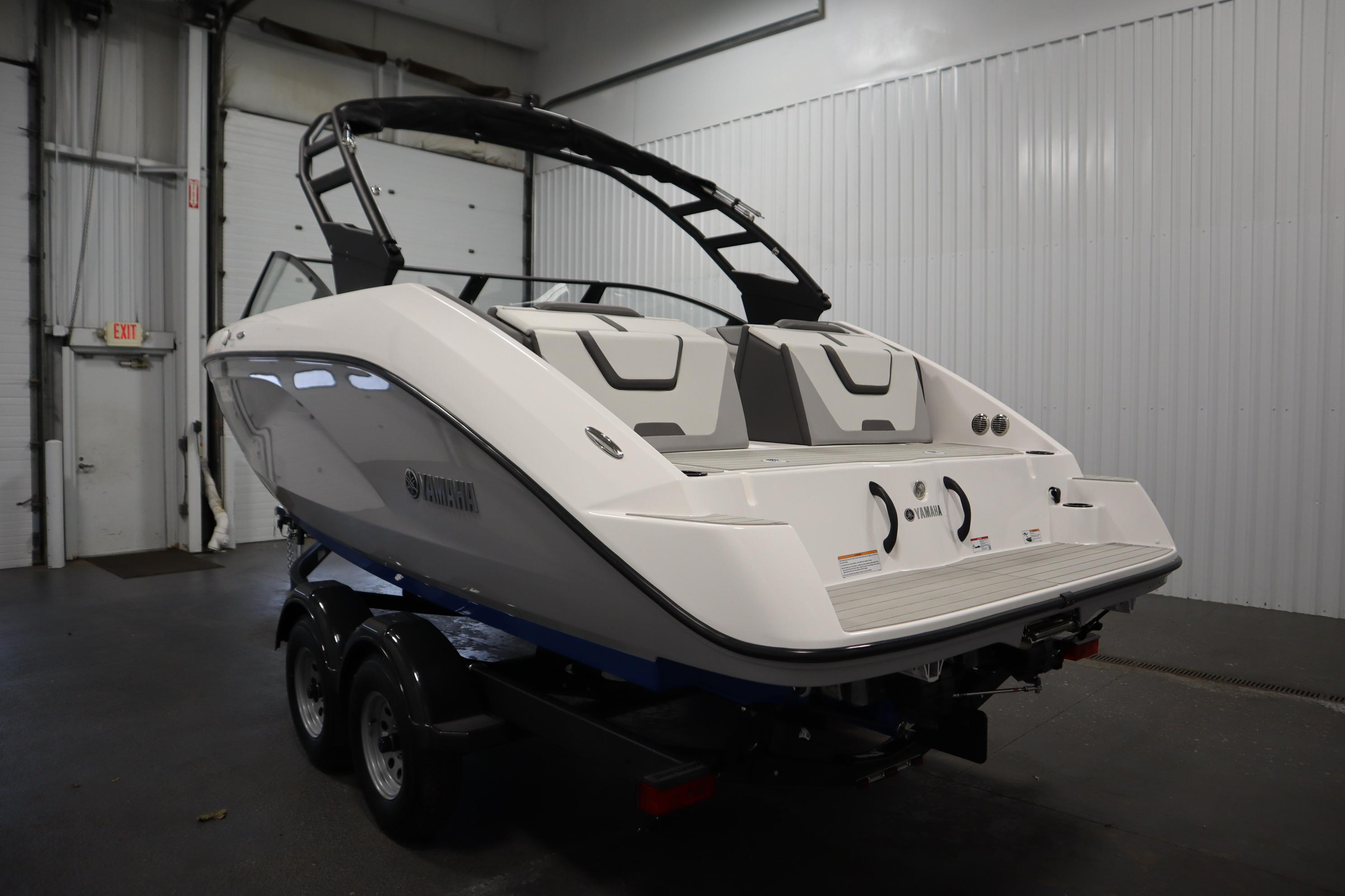 2026 Yamaha Boats AR220 in a showroom, showcasing sleek design and modern features.