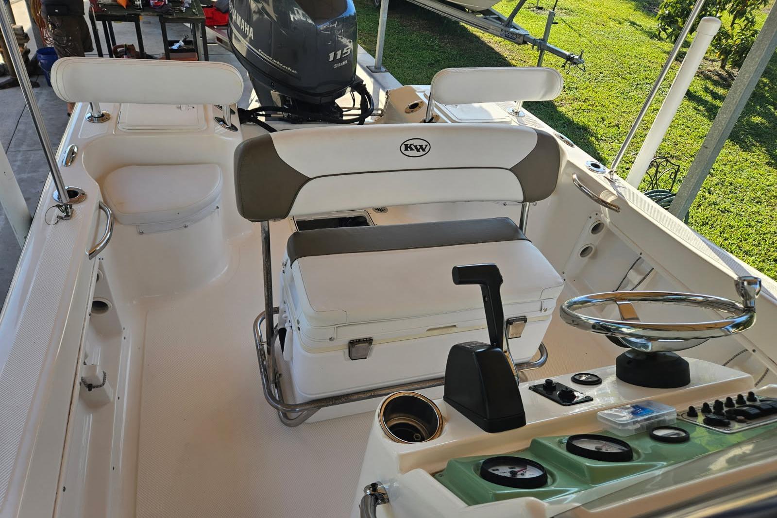 2013 Key West 176 Center Console boat interior with steering wheel and Yamaha engine.