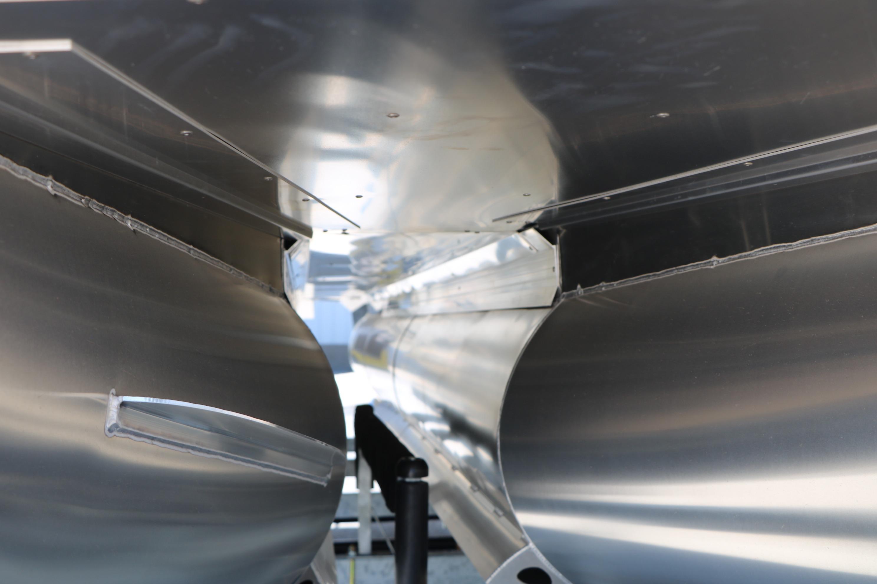 Close-up of Evotti 725 CS Tri-Toon pontoons, showcasing sleek aluminum construction, 2026 model.