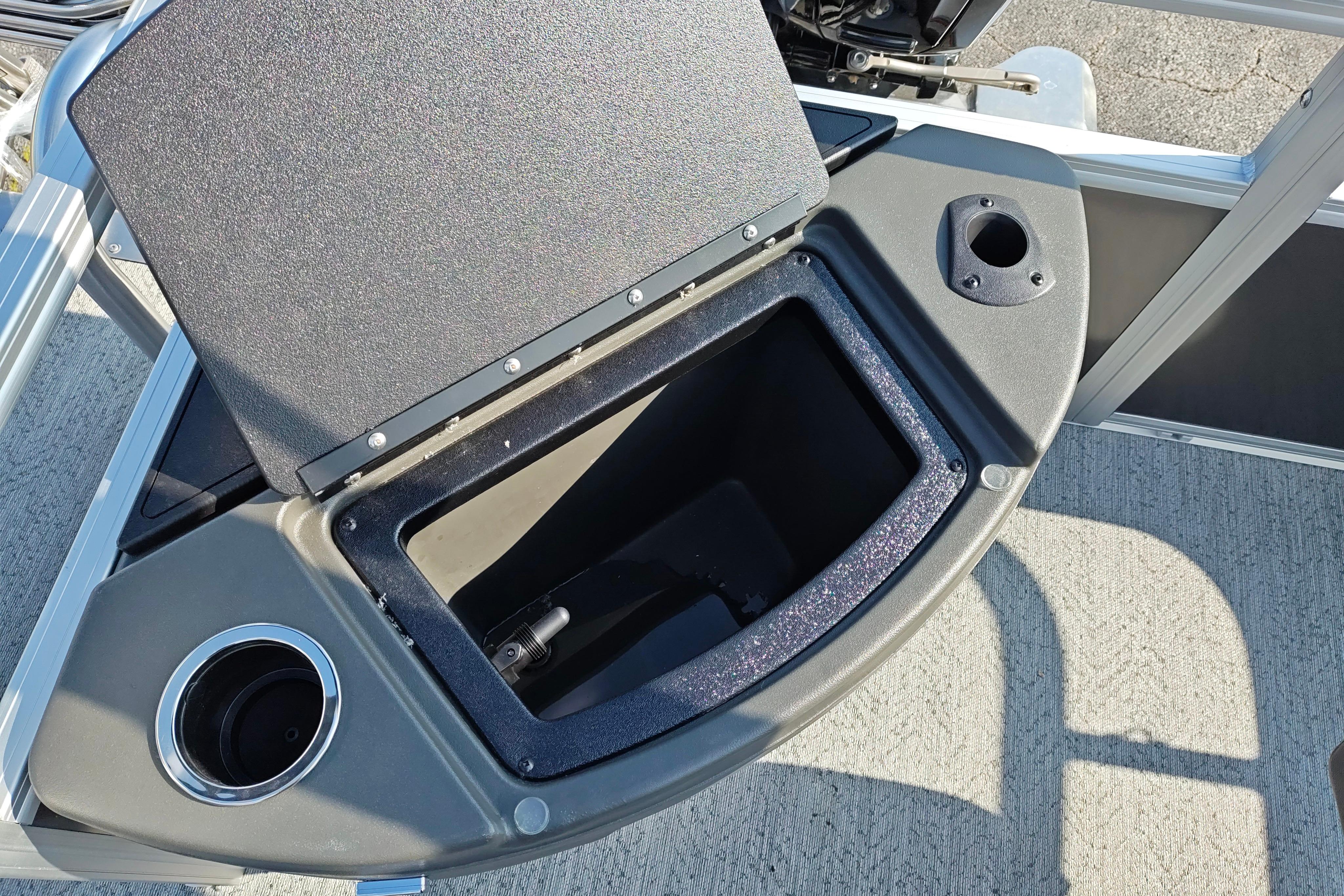 2026 Sun Tracker Bass Buggy 18 DLX storage compartment with cup holder and rod holder.