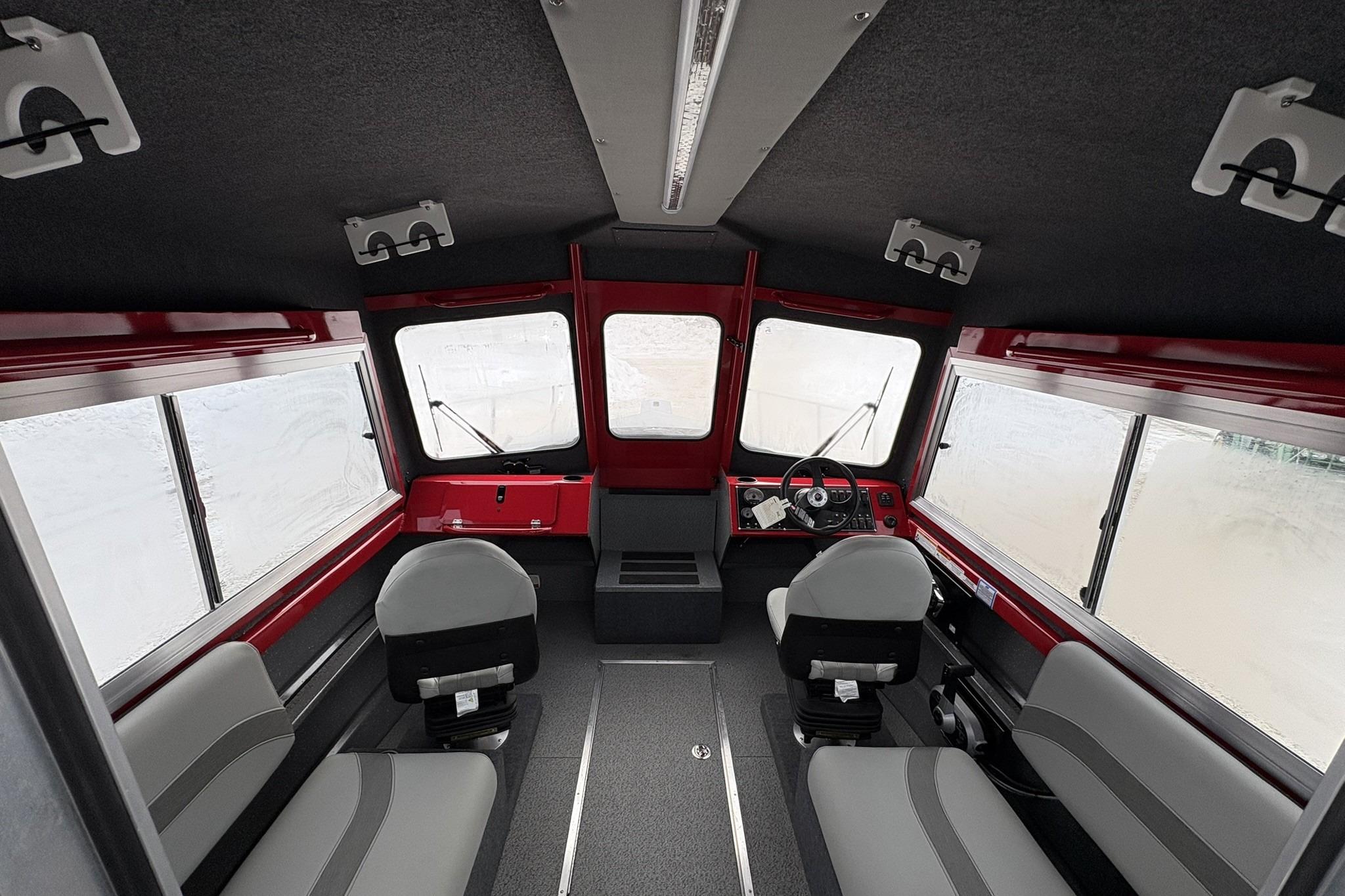 Interior of 2024 Spartan 240 Maximus Pro boat, featuring modern seating and dashboard.