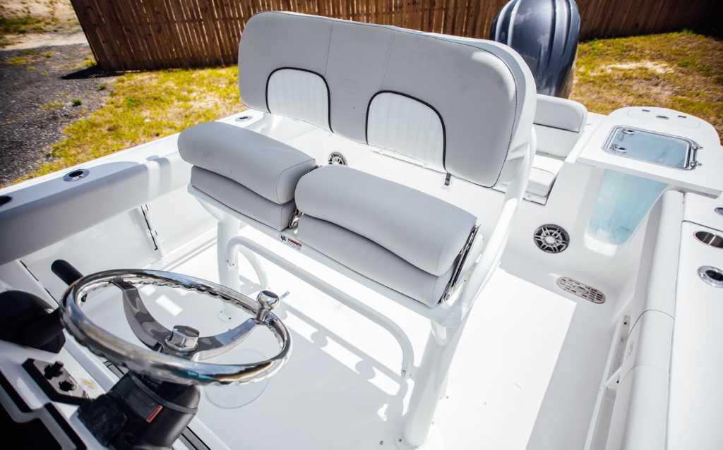 2021 Sea Fox 248 Commander boat interior with steering wheel and cushioned seating.