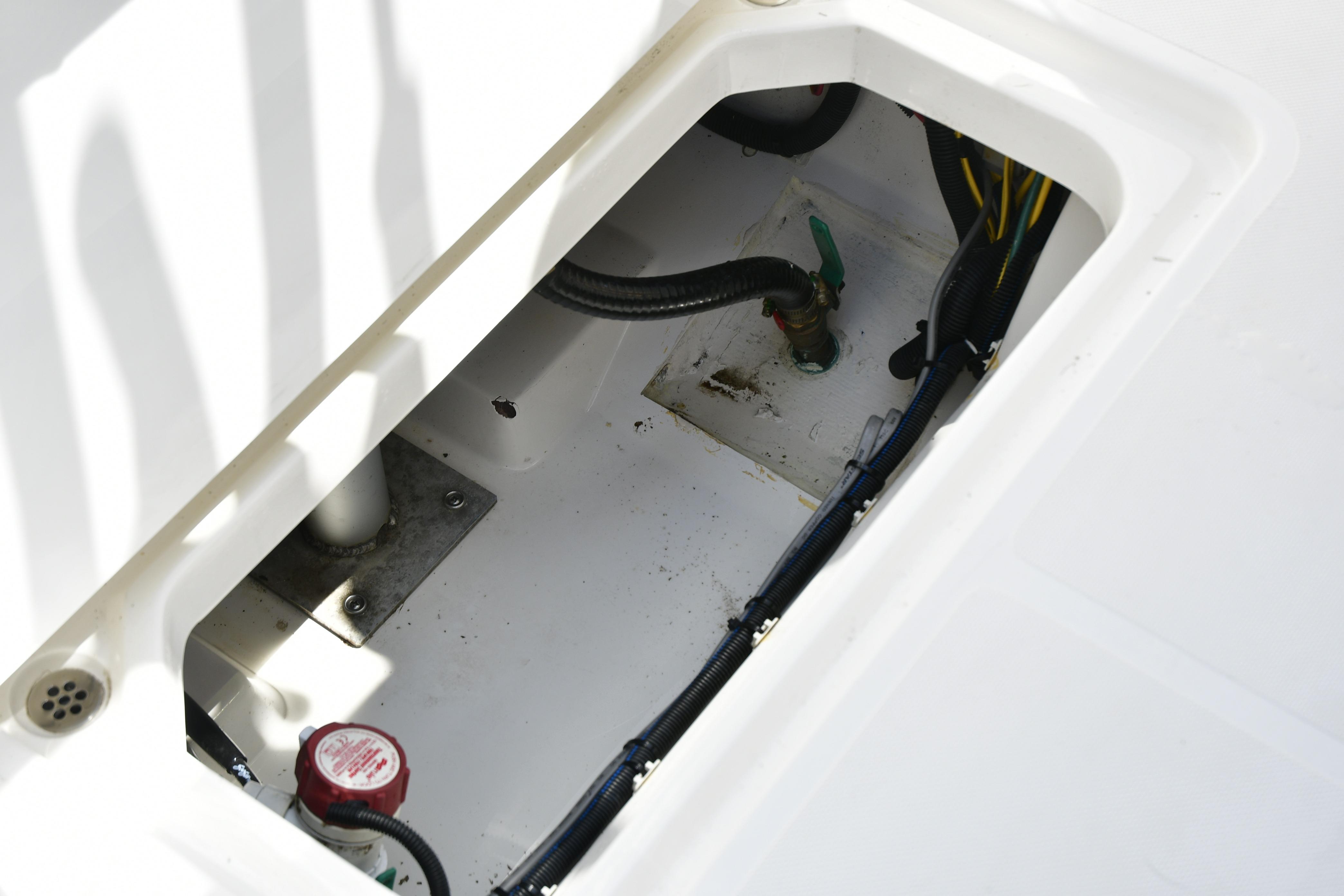 2020 Pursuit C 238 Center Console boat compartment with visible wiring and plumbing.