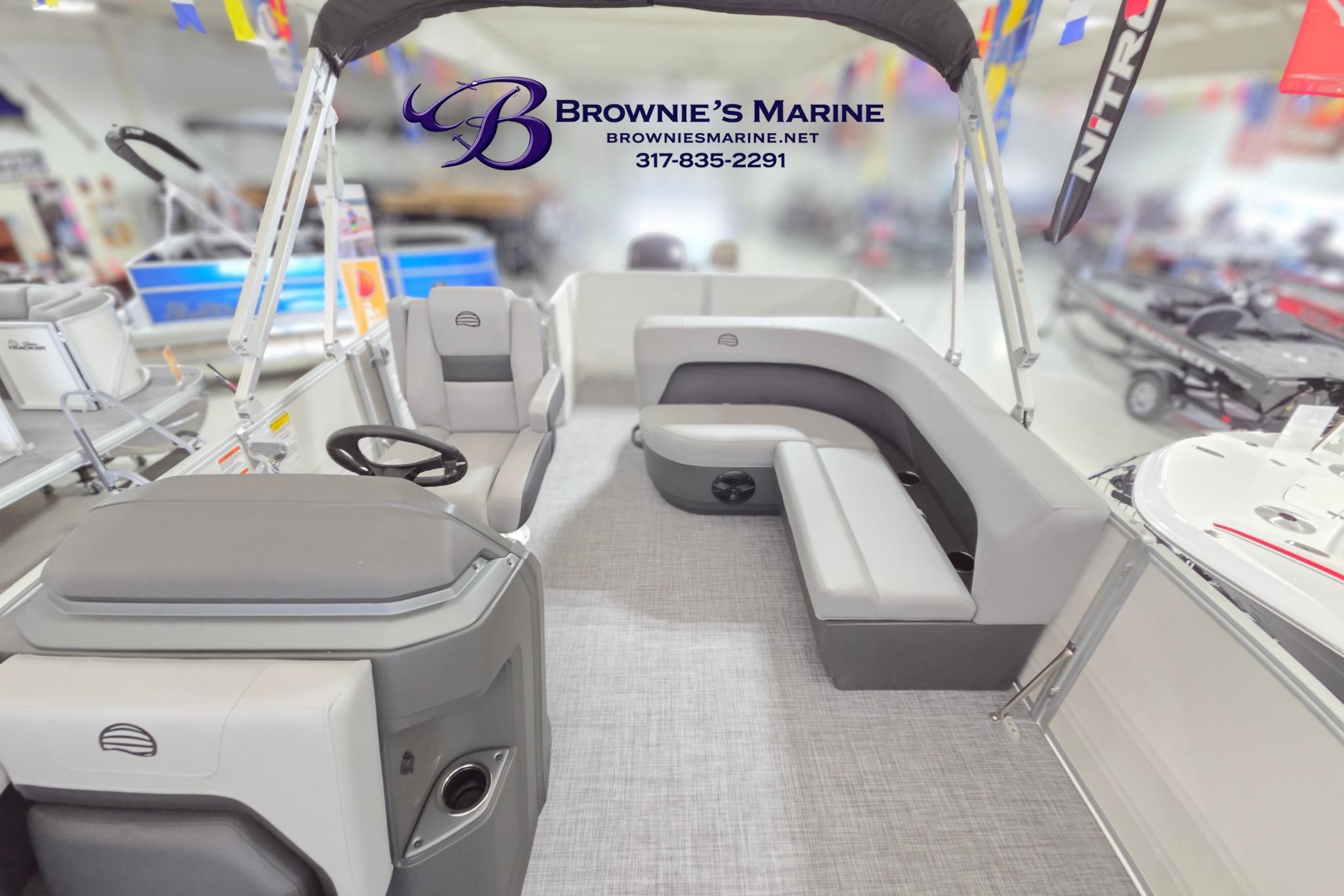 2026 Sun Tracker Party Barge 18 DLX interior with seating and steering console at Brownie's Marine.