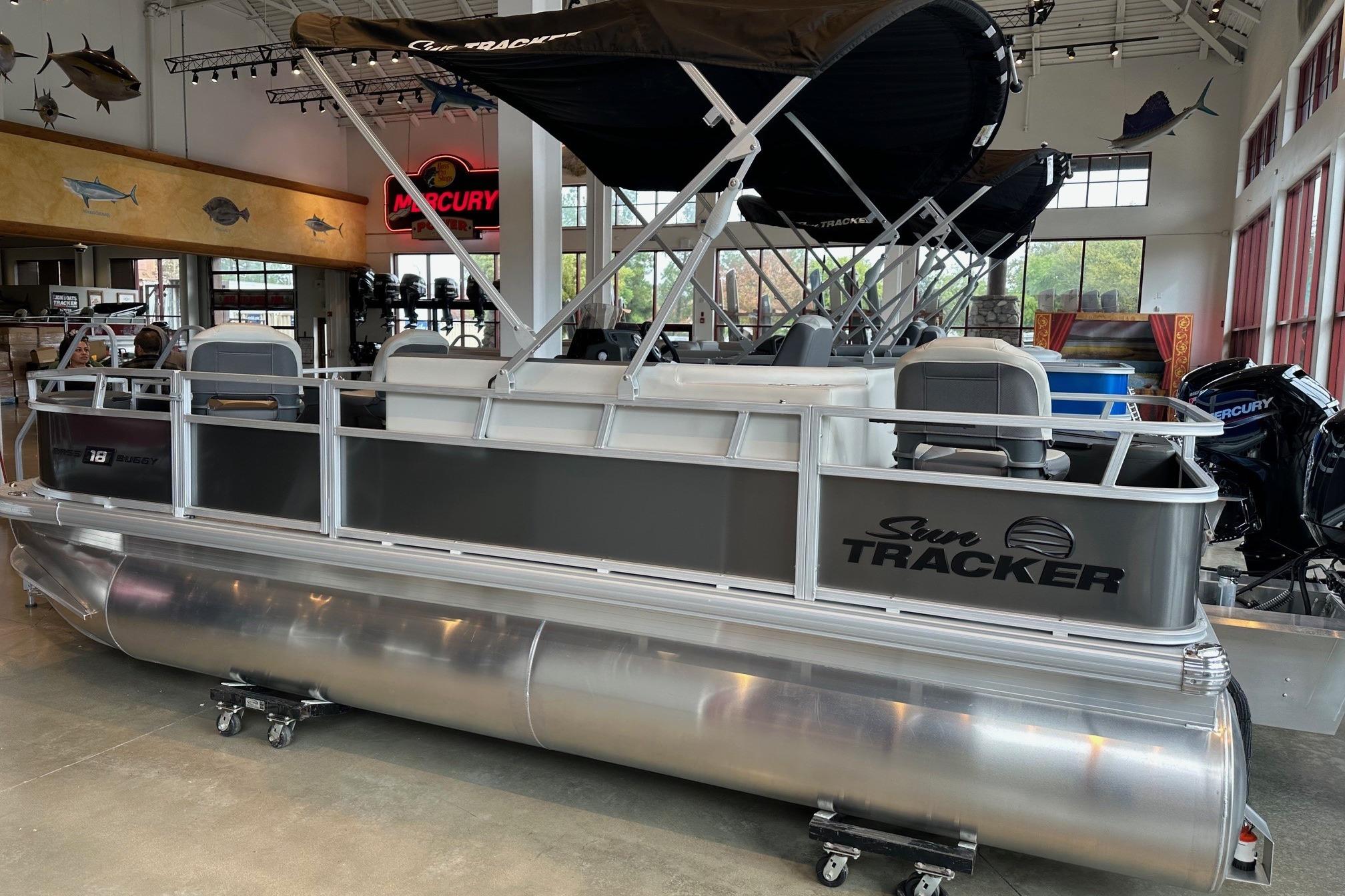 2026 Sun Tracker Bass Buggy 18 DLX pontoon boat displayed in showroom.