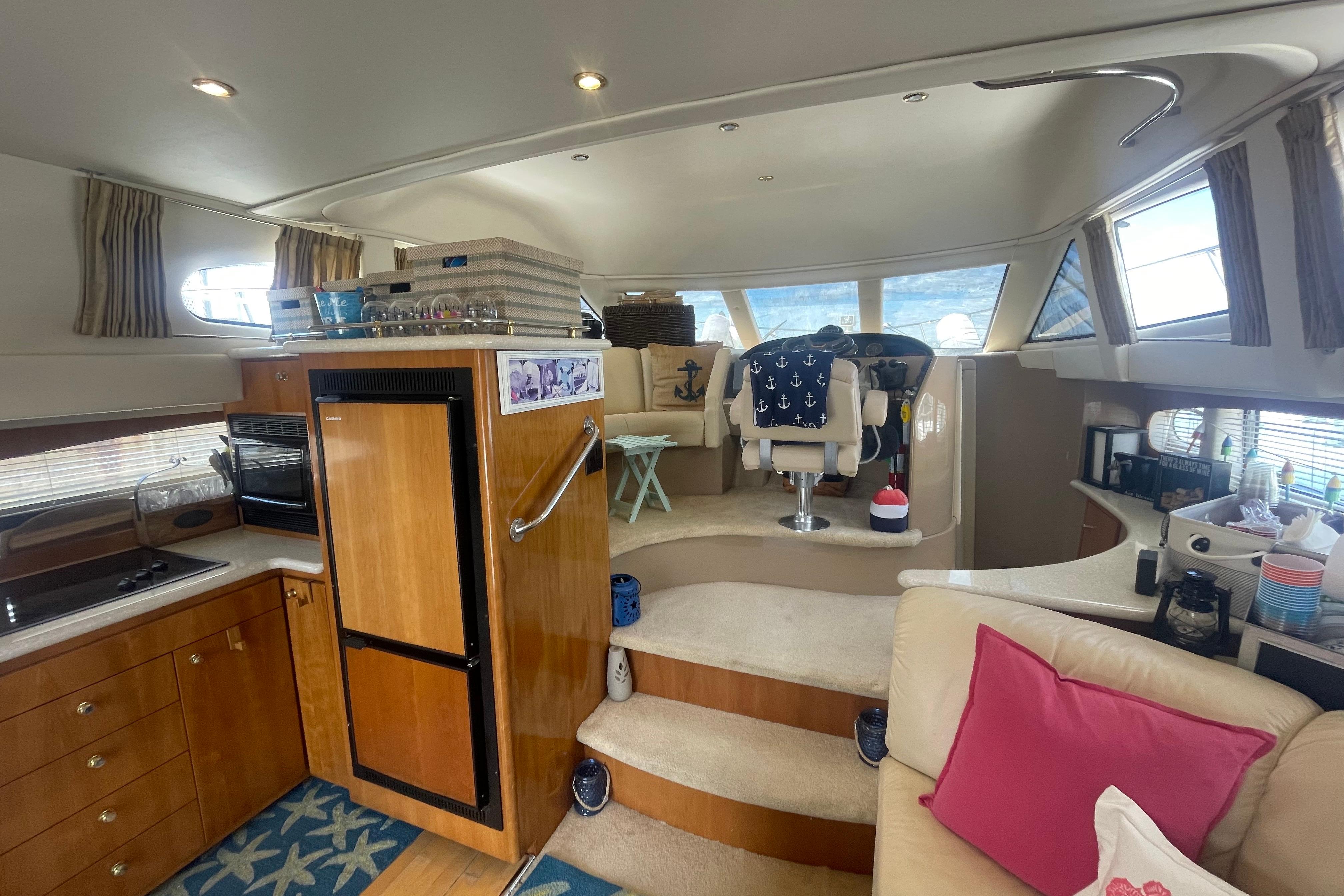 Interior of 2002 Carver 410 Sport Sedan yacht, featuring kitchen and helm area.