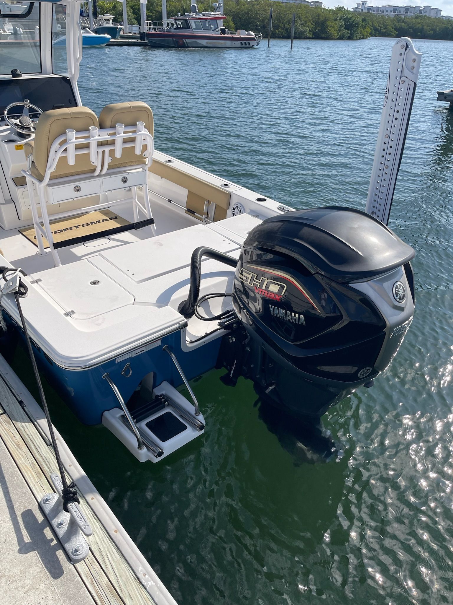A 2022 Sportsman Masters 247 Bay Boat is docked. It features a Yamaha outboard motor.