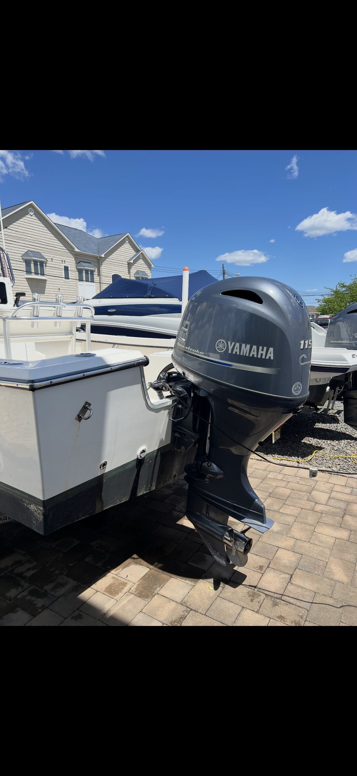 A 2020 Center Console Maycraft with a Yamaha outboard motor on a paved yard.