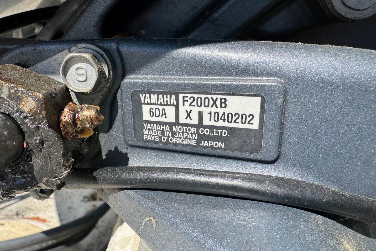Yamaha F200XB engine label on a 1997 Maycraft 23 boat, showing model and serial number.
