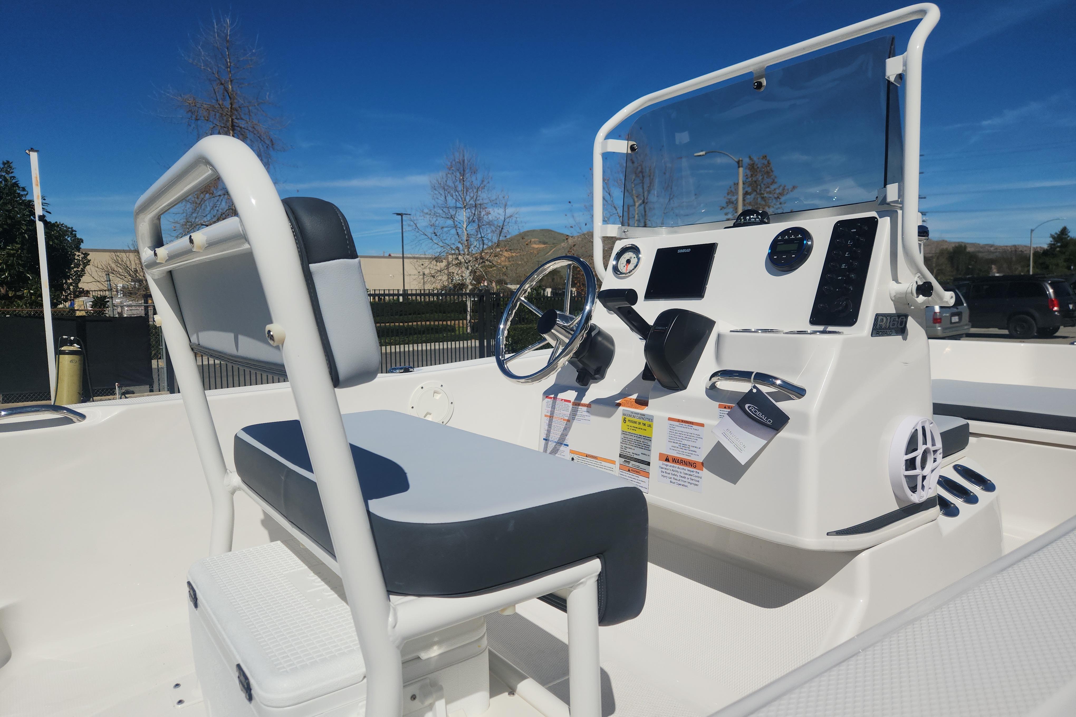 2026 Robalo R160 Center Console boat interior with steering wheel and seating.