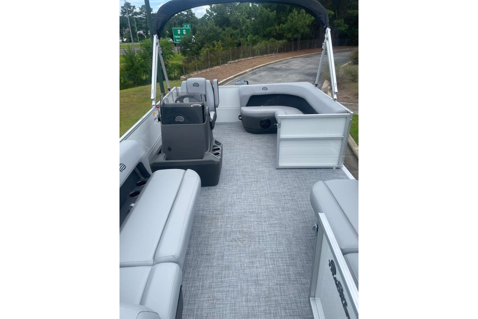 2026 Sun Tracker Party Barge 16 DLX interior with gray seating and open deck layout.