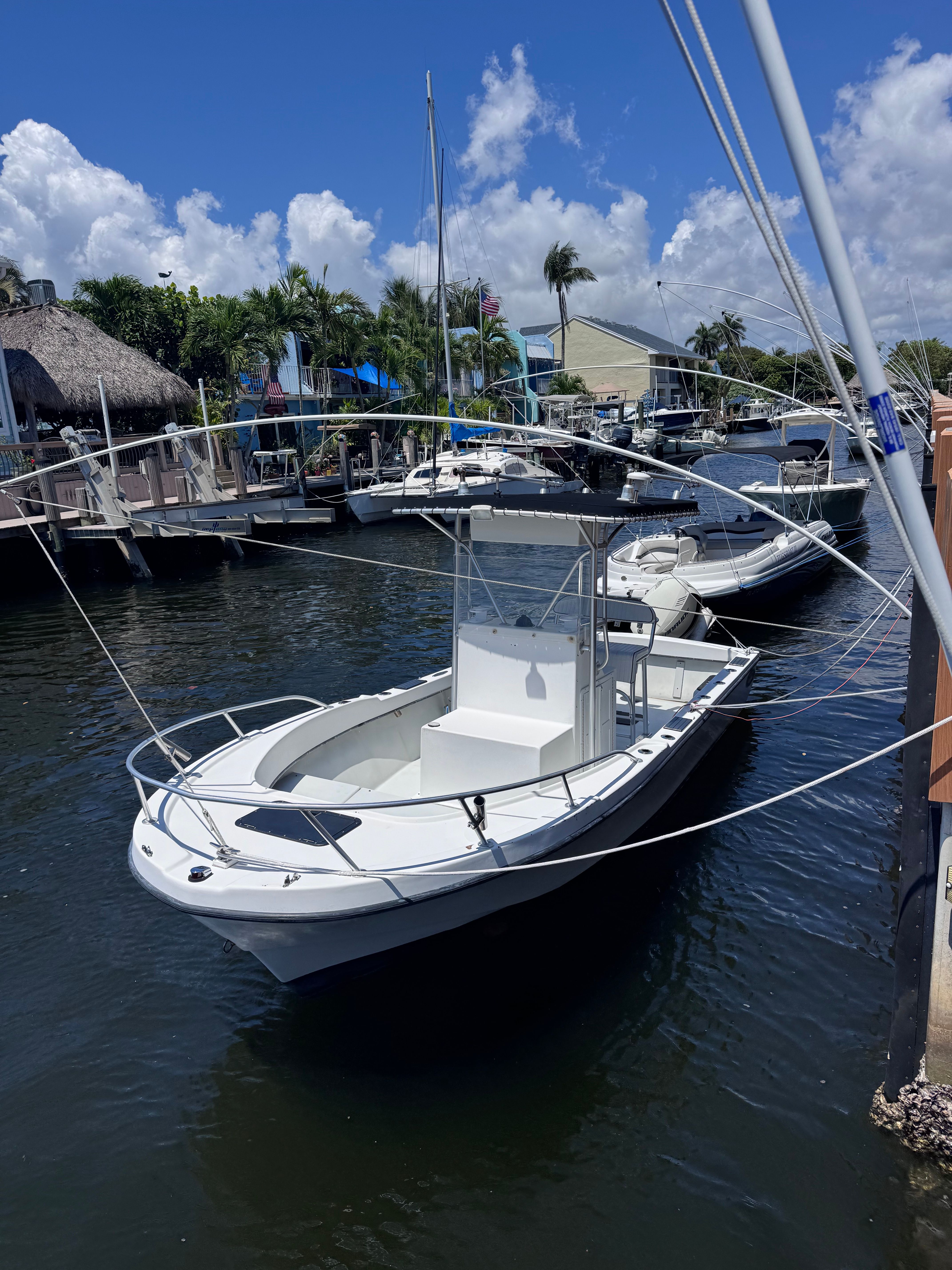 1998 Dusky 20.3 boat docked in marina on a sunny day.
