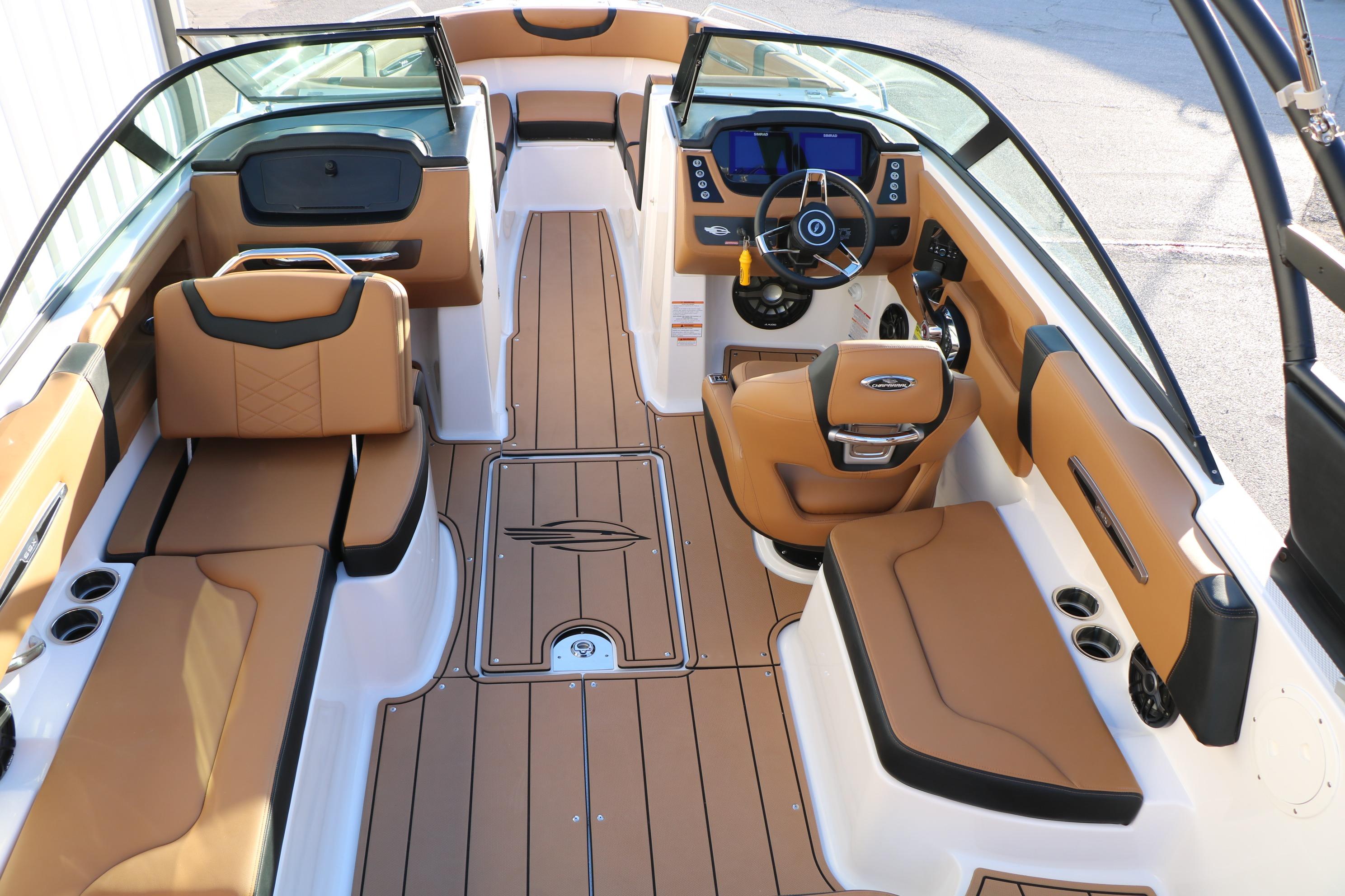 2026 Chaparral 247 SSX boat interior with tan seating and modern dashboard design.