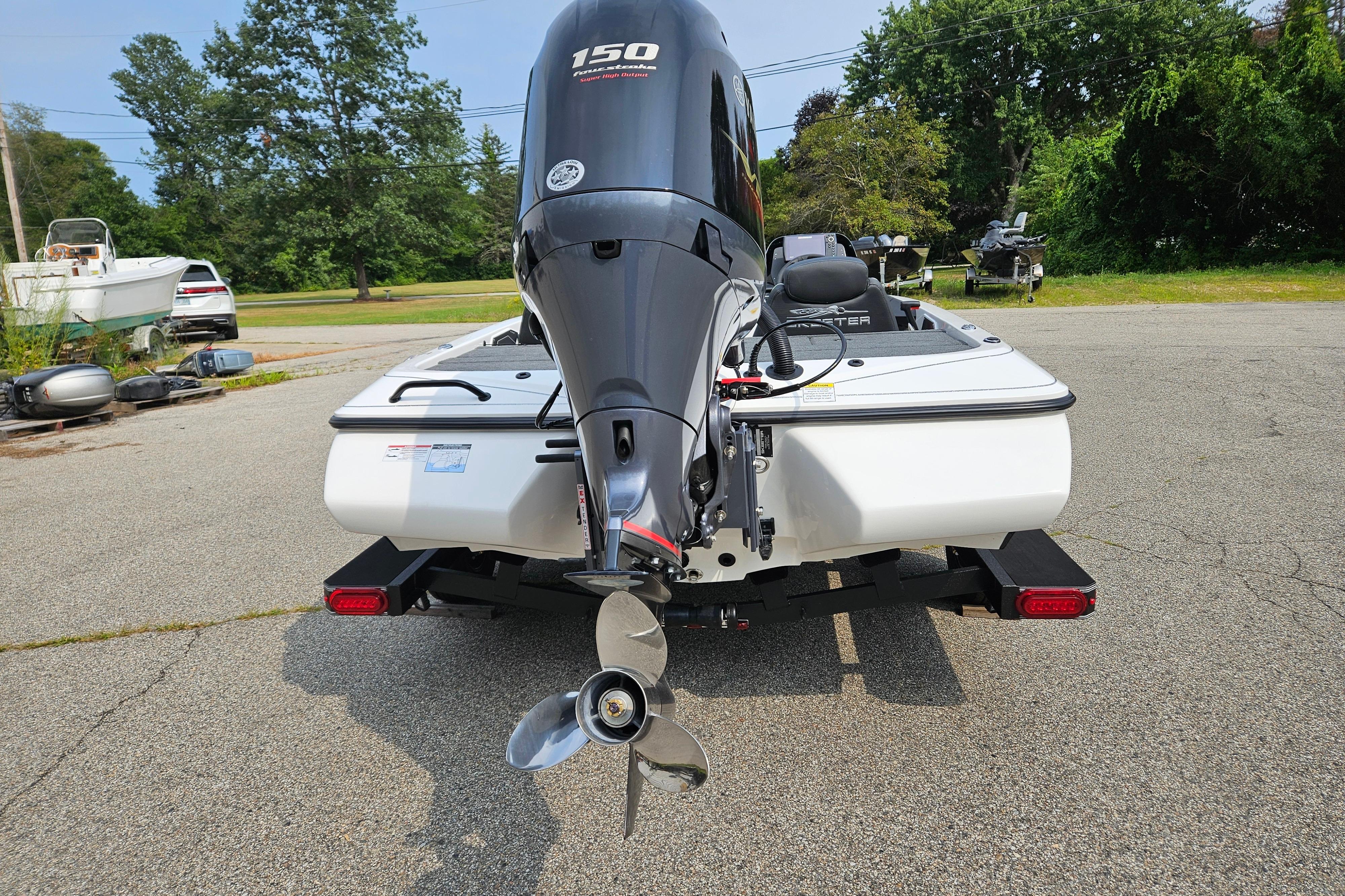 2026 Skeeter ZX150 boat with powerful outboard motor, parked on a sunny day.