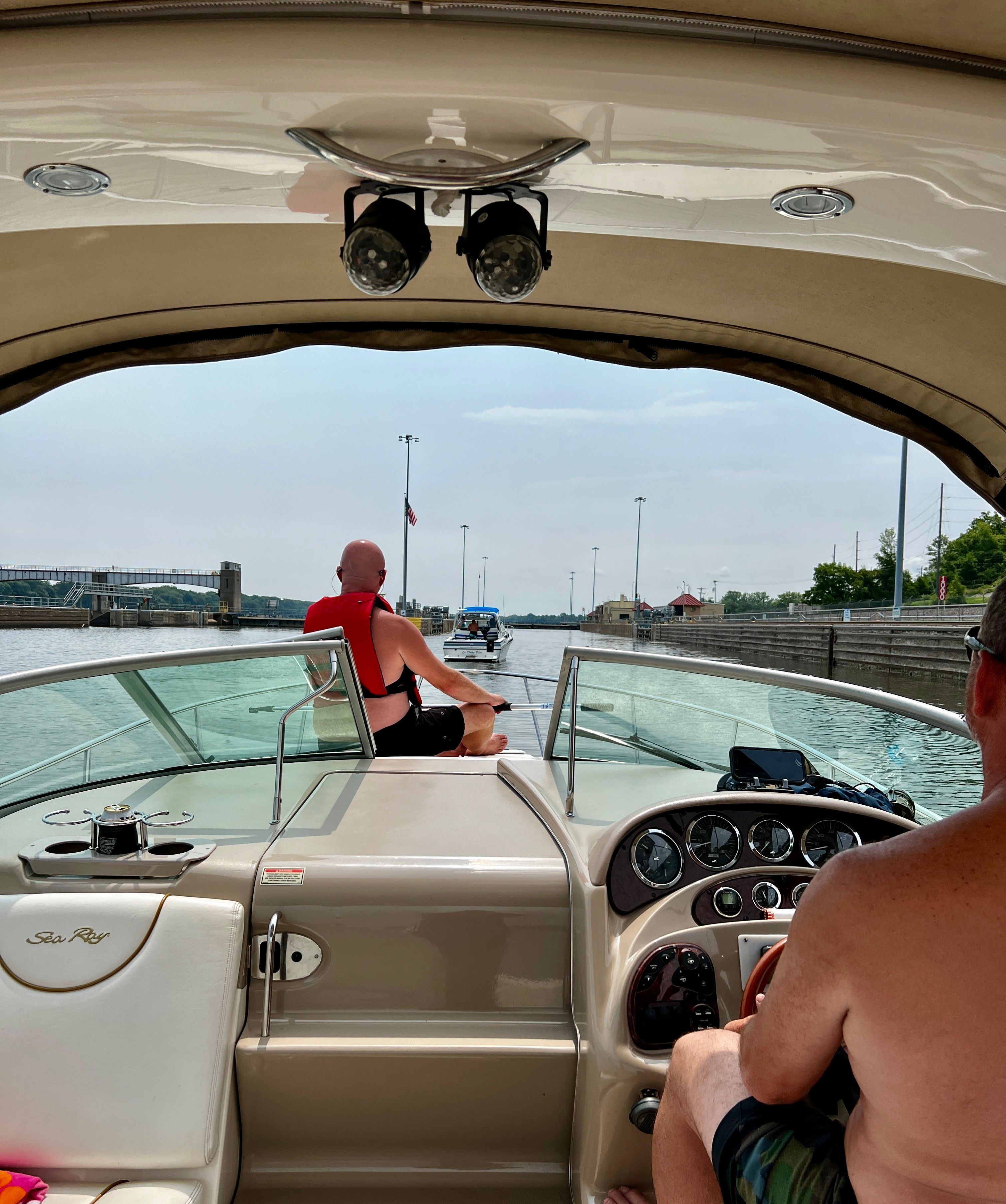 2003 Sea Ray Sundancer 280 on water with two people aboard.
