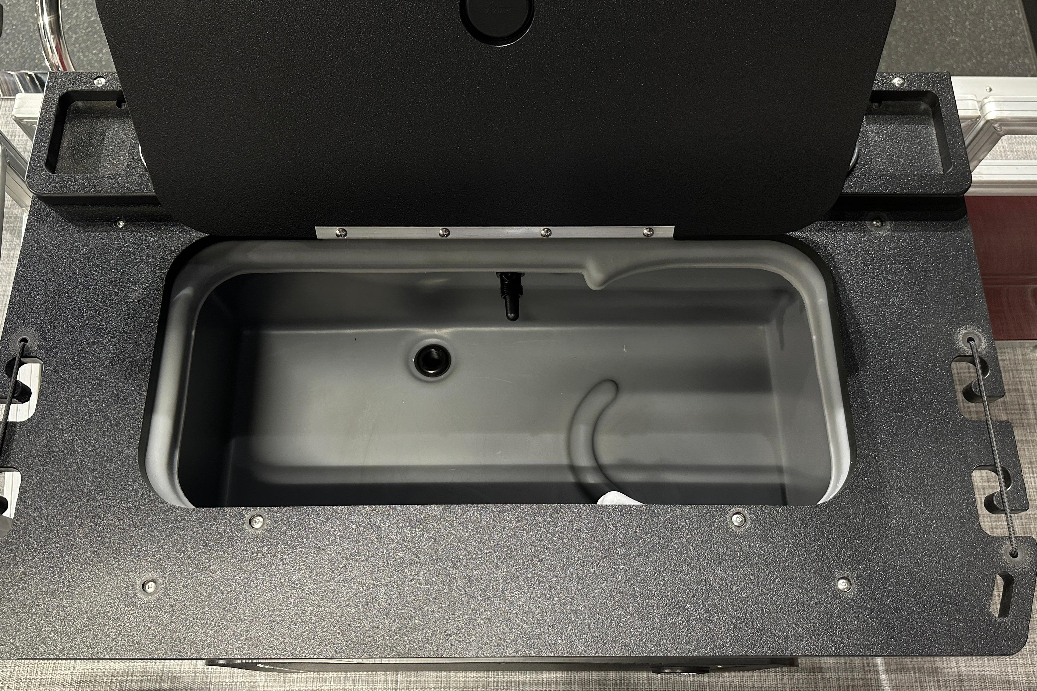 Open storage compartment on 2026 Sun Tracker SportFish 22 DLX boat.