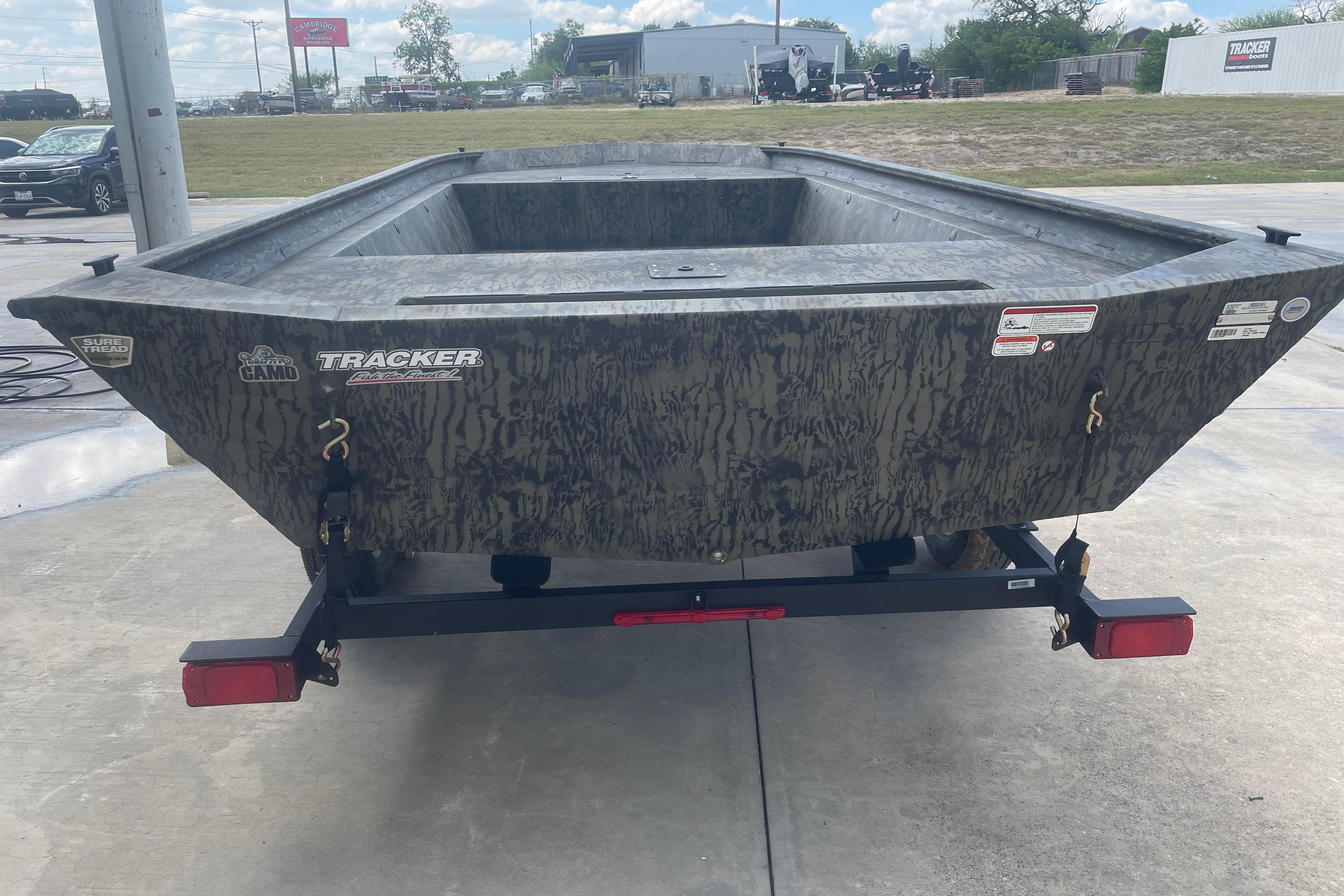 2026 Tracker Grizzly 1860 Utility boat on trailer, camo design, outdoor setting.