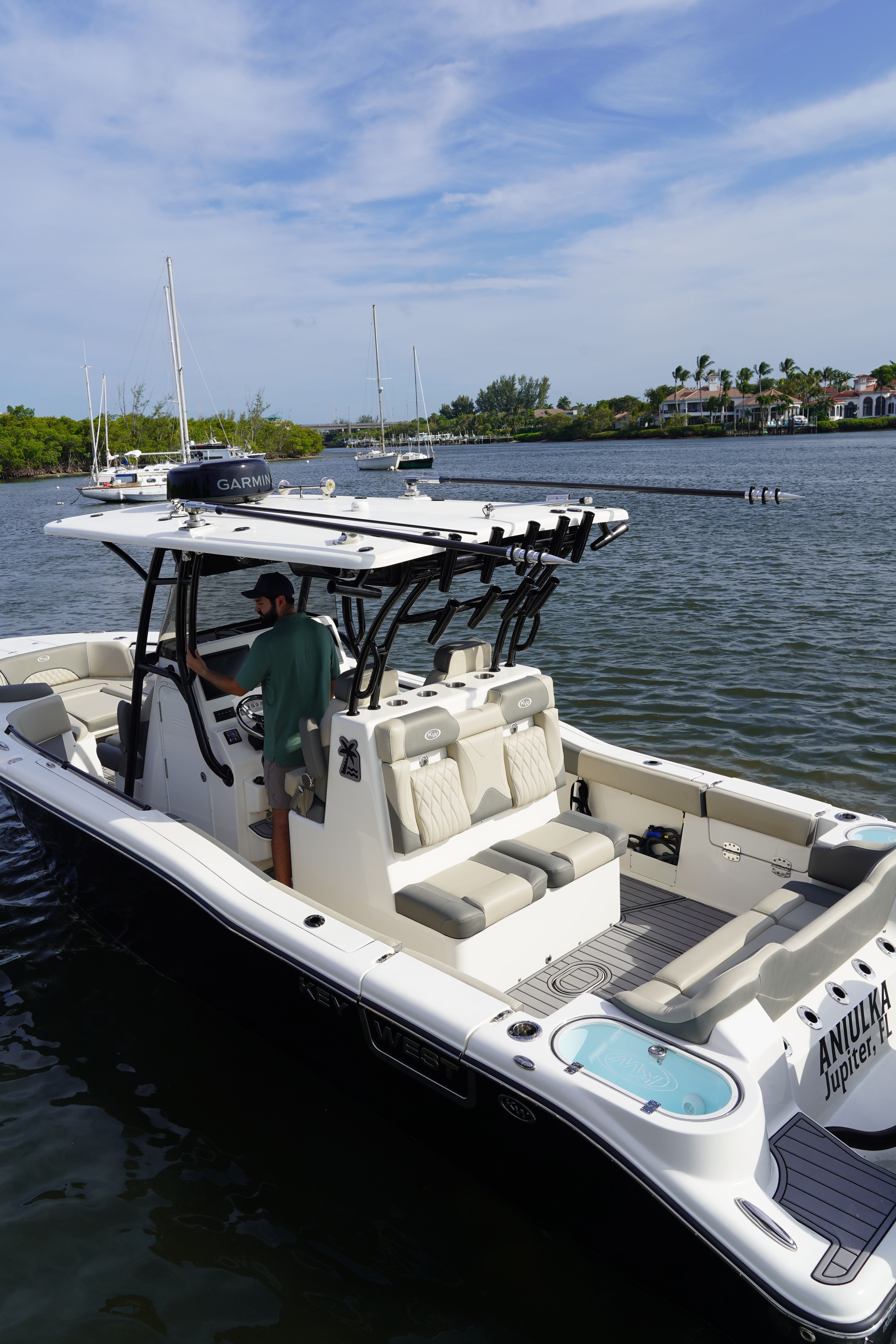 A modern motorboat with spacious deck and seating on calm water.