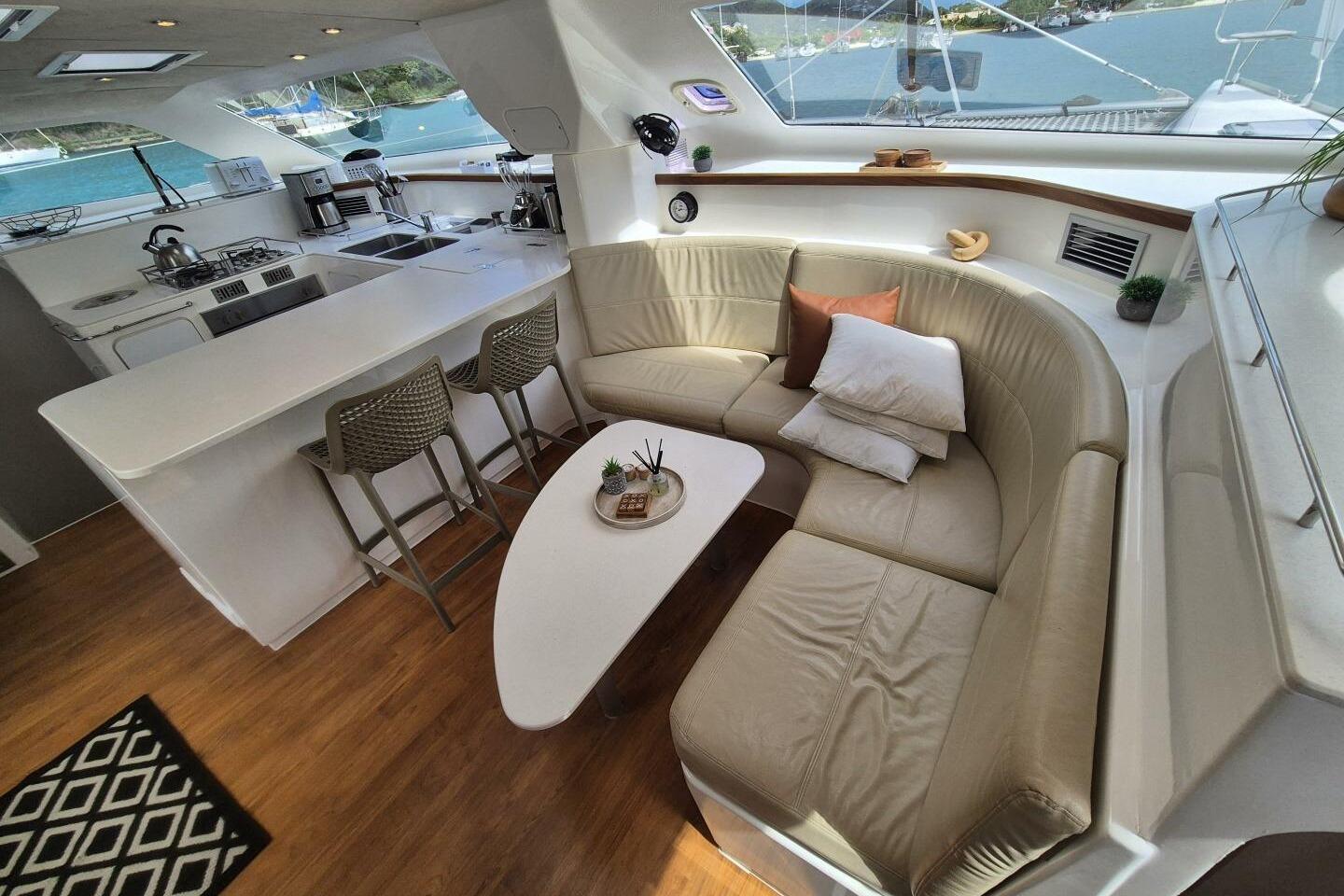 Luxurious interior of a 2017 Voyage 480 yacht with modern kitchen and cozy seating area.