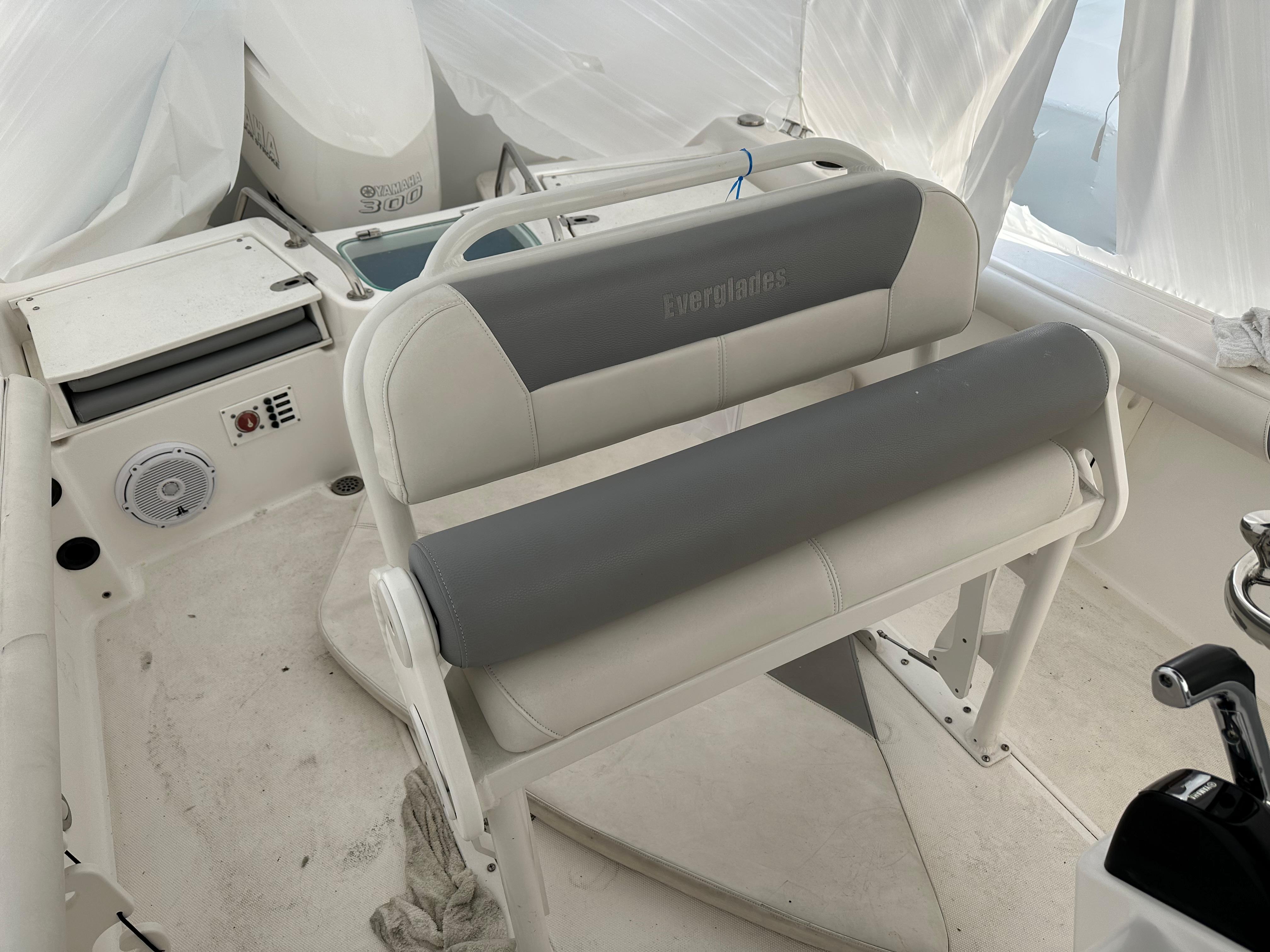 2018 Everglades 230CC boat interior with cushioned seating and control panel.