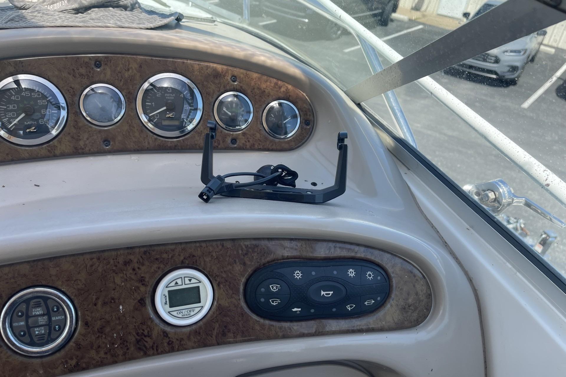 Dashboard of a 2000 Sea Ray Sundancer 260 boat with gauges and controls.